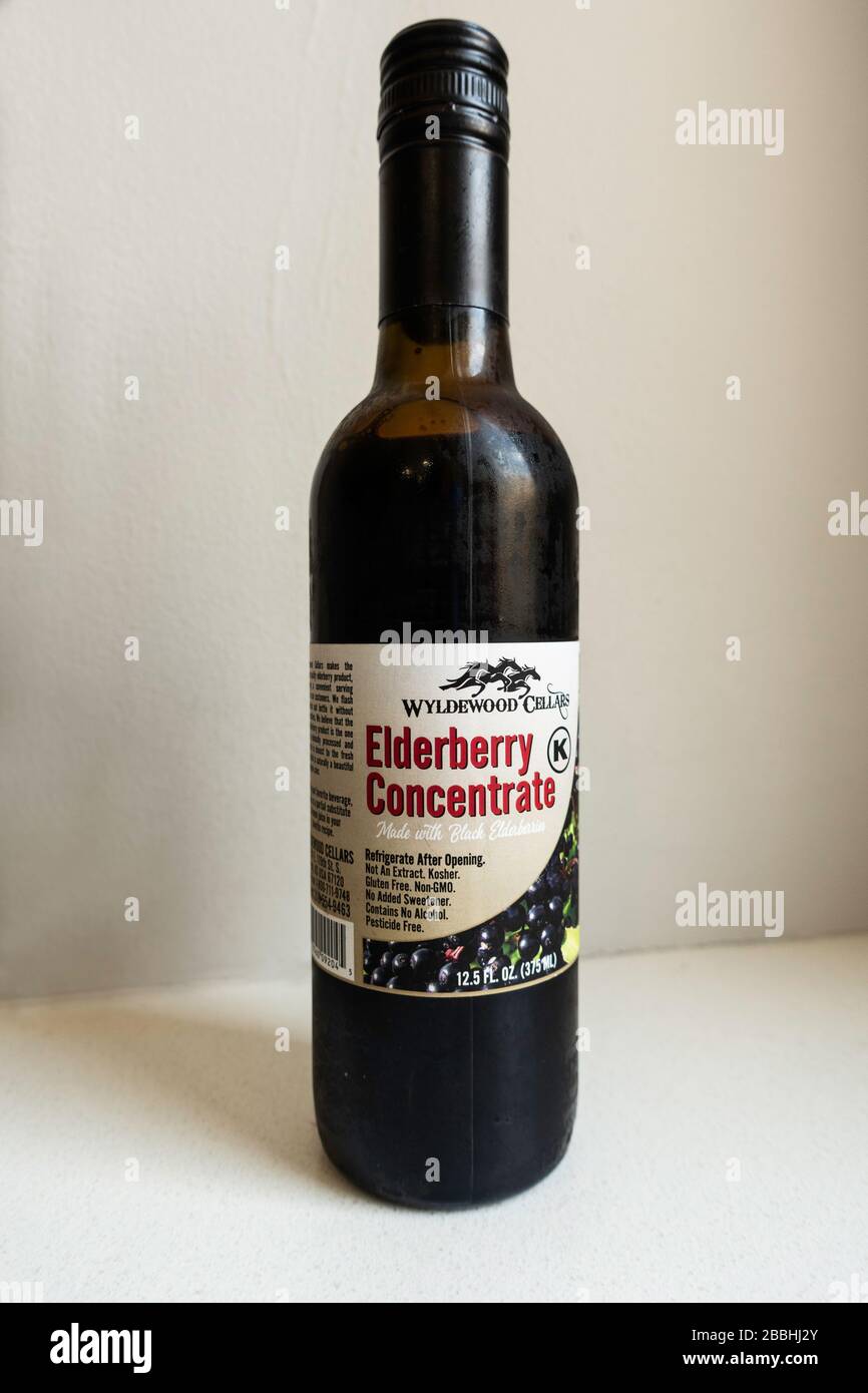 Bottle of elderberry concentrate for strengthening the immune system. Coronavirus, Covid-19 response. Stock Photo