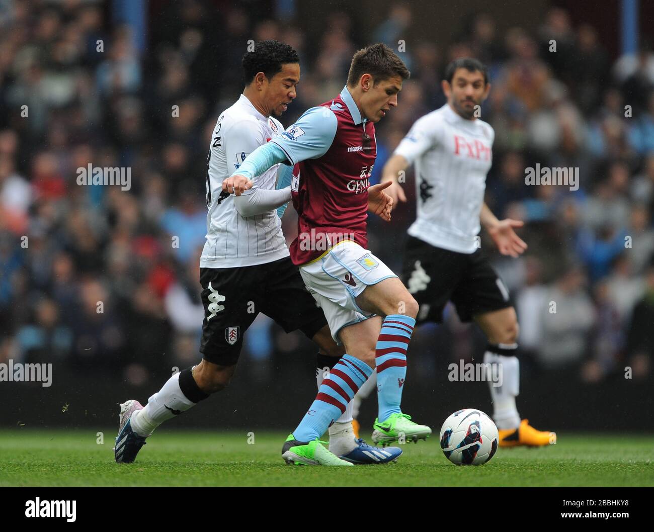 Aston Villa's Andreas Weimann (centre) and Fulham's Kieron Richardson (left) battle for the ball. Stock Photo