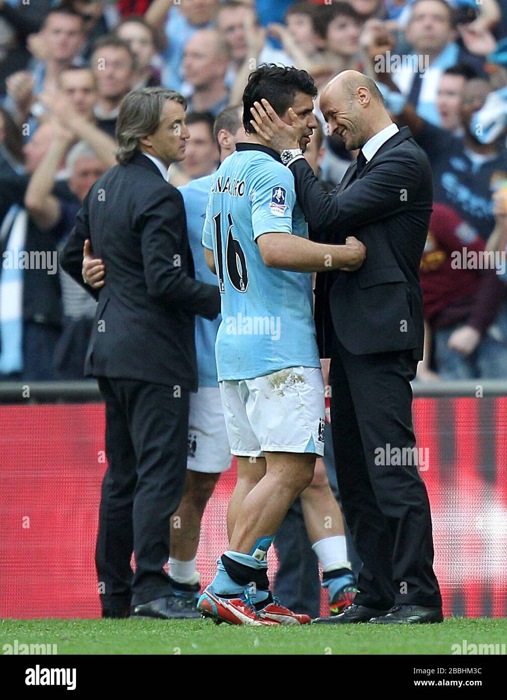 Manchester City's Sergio Aguero celebrates after the final whistle with Manchester City colleague Attilio Lombardo Stock Photo