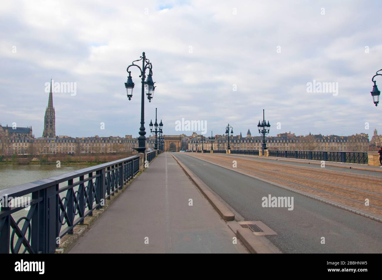 Beautiful view to the bridge over the Garonne river and to the city. Cloudy winter day, Pont de Pierre, Bordeaux, France Stock Photo