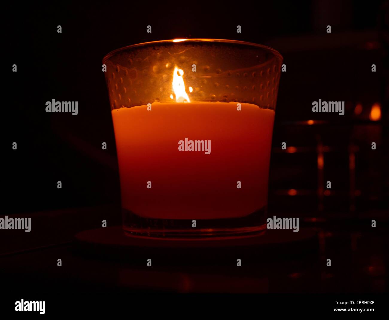A candle was photographed in low light with candlelight illuminating