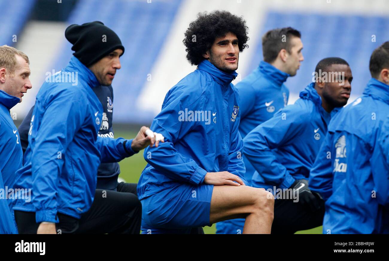 Everton's Marouane Fellaini (centre) warms up with team-mates during the open training day at Goodison Park Stock Photo