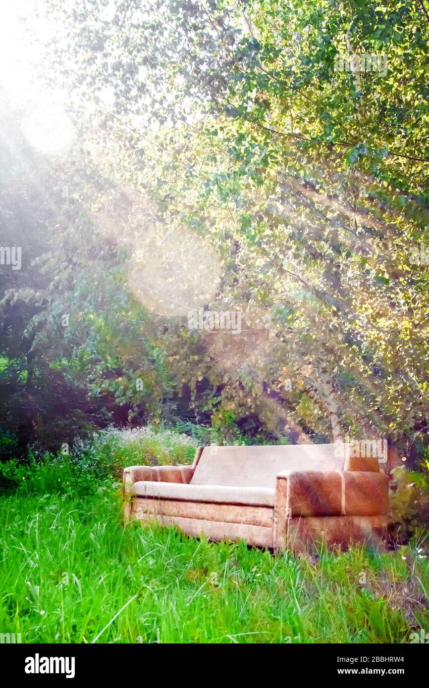 Empty old secluded sofa among nature. Solitude concept Stock Photo
