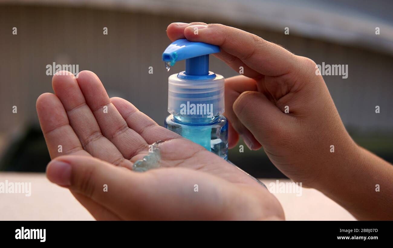 Children washing hands with alcohol based gel to protect from corona virus. Stock Photo