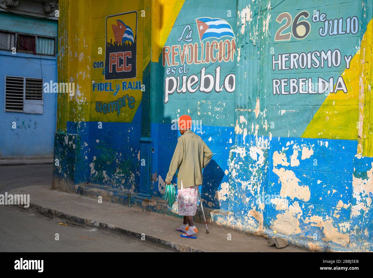 Older woman and Murals  on outside of produce market, Havana Vieja, Cuba Stock Photo
