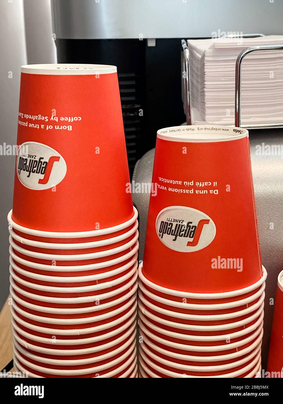 Segafredo Disposable coffee cups piles in cafe. Street food and drinks take away waste problem