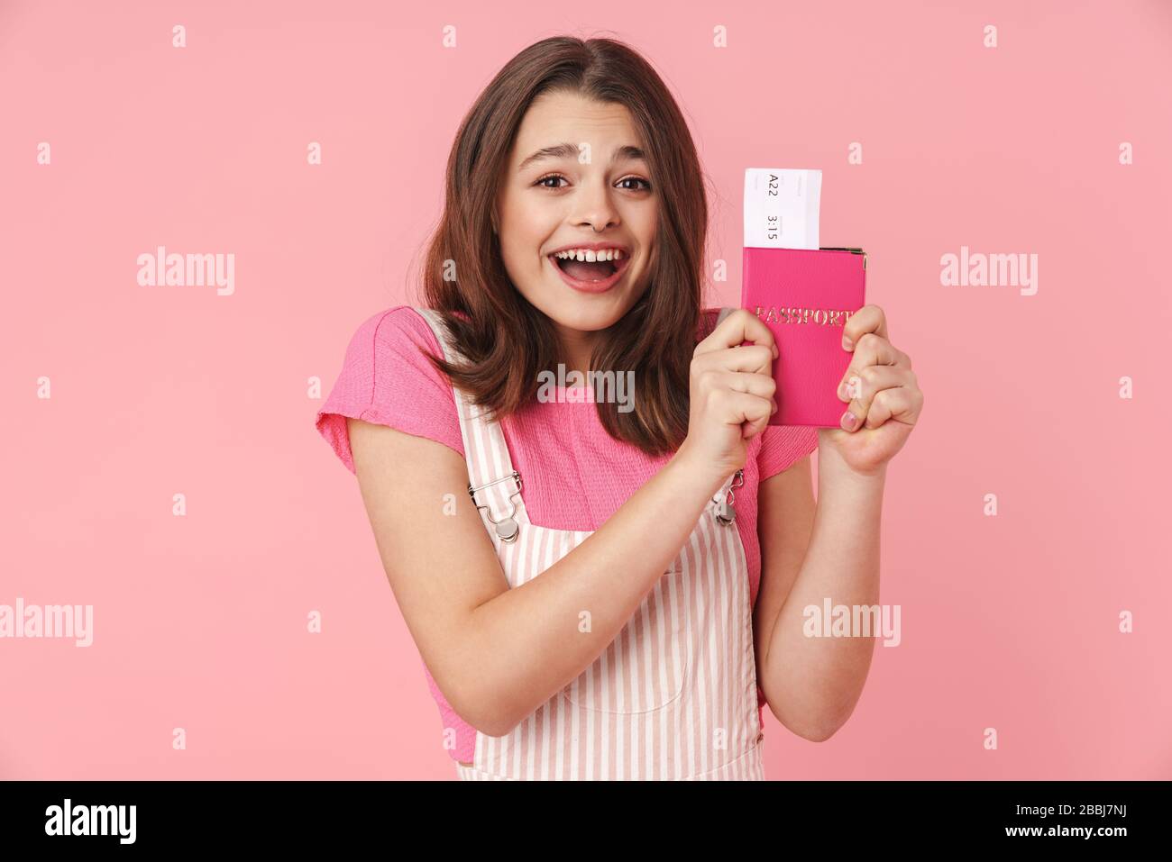 Photo of lovely excited girl wearing nose ring holding passport with