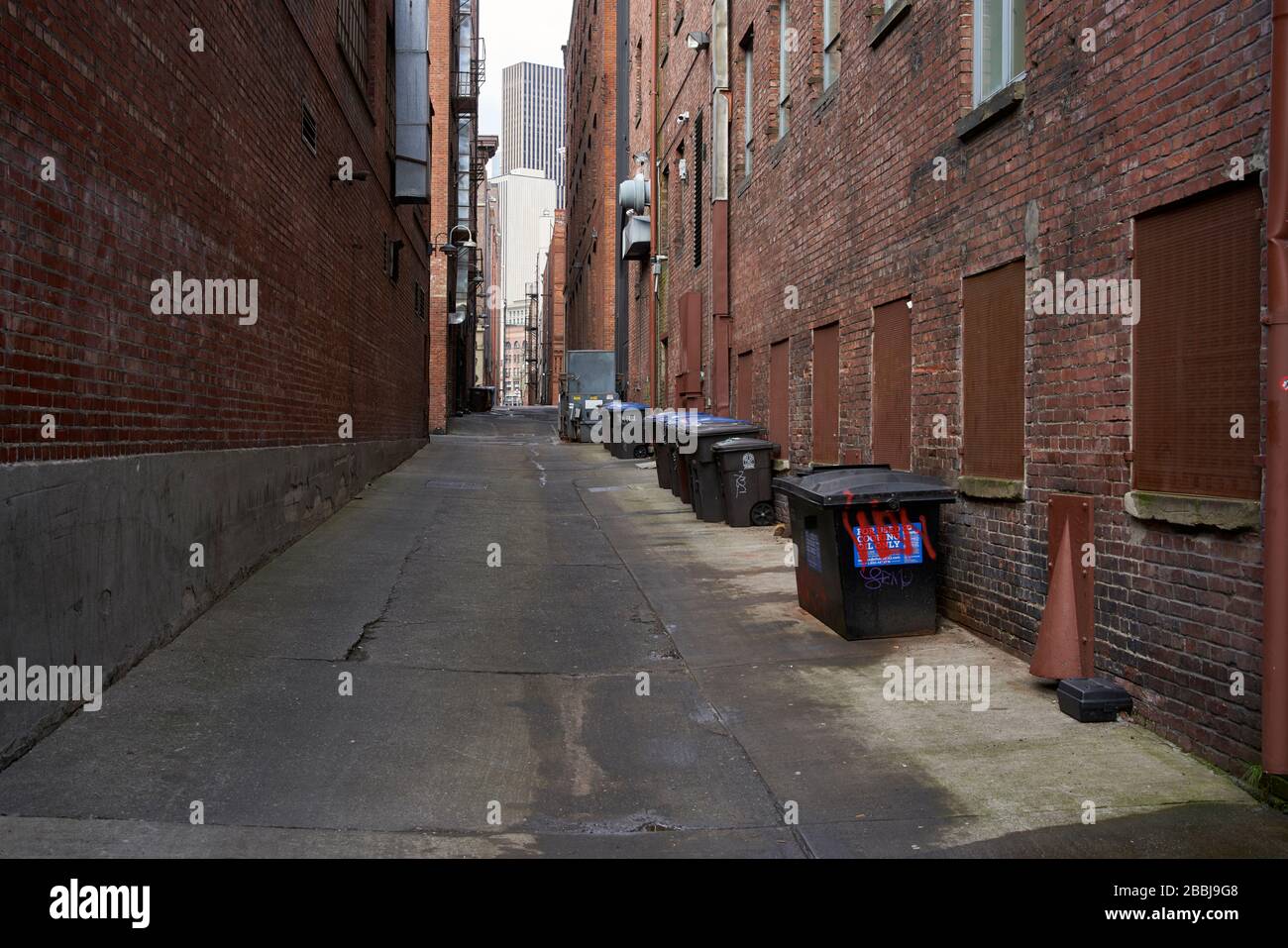 Garbage dumpsters in downtown Seattle alleyway. Stock Photo