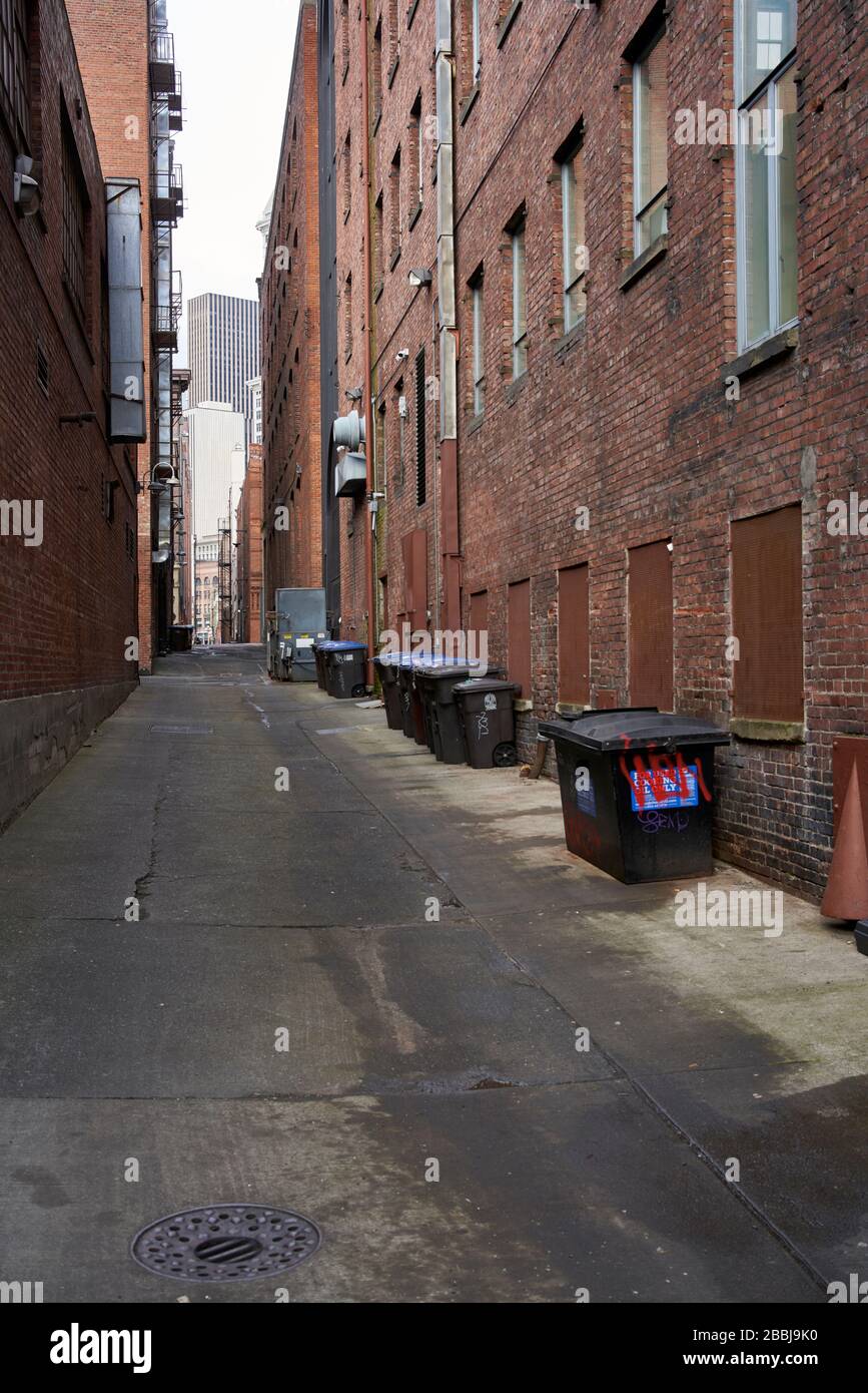 Garbage dumpsters in downtown Seattle alleyway. Stock Photo