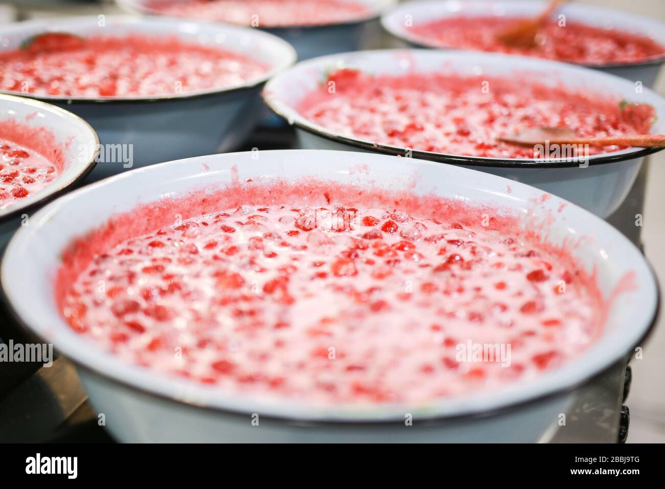 Strawberry jam cooking process. Organic traditional jam manufacturing