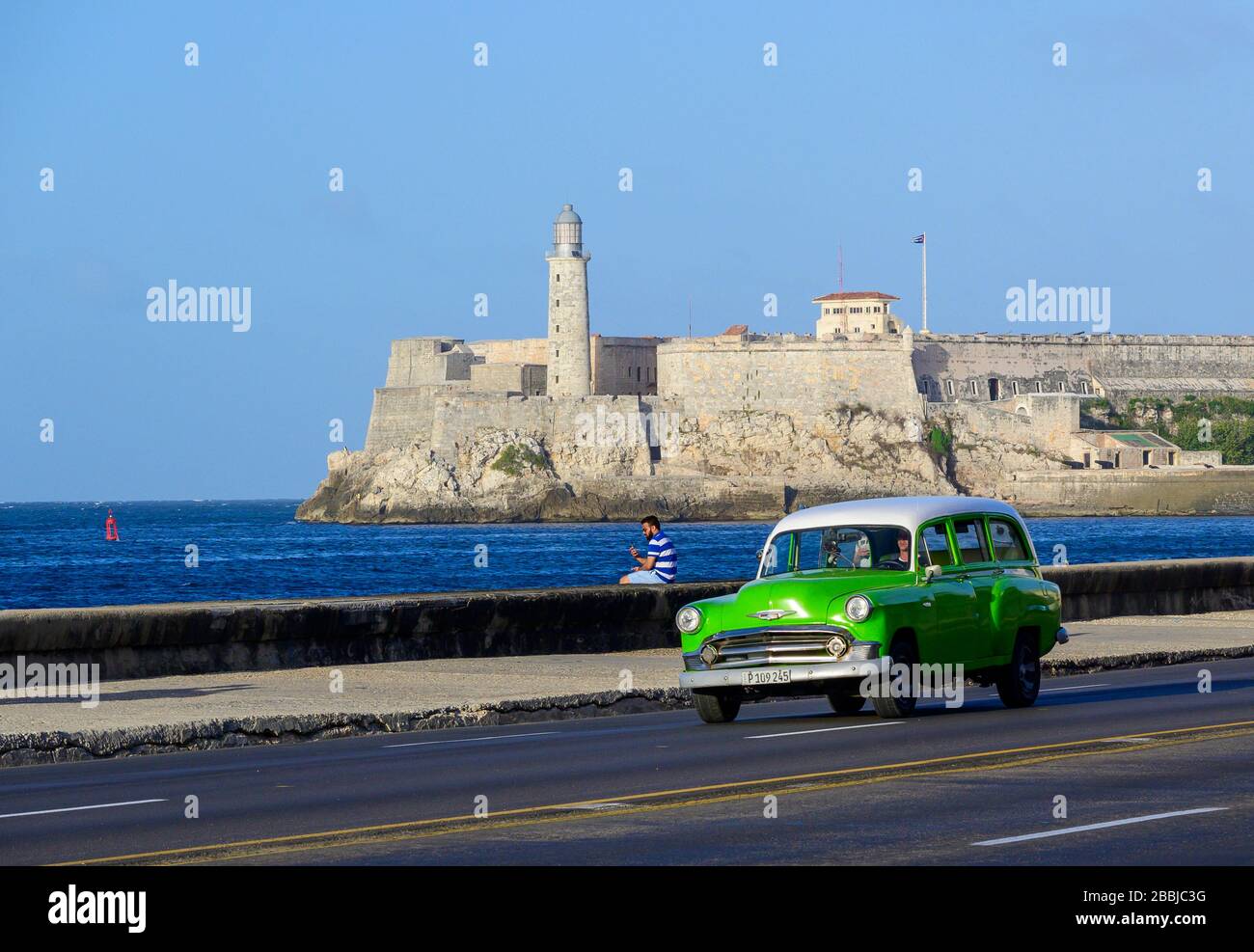 Classic fifties Chevrolet wagon,  on the Malecon, with Morro Castle beyond, Centro, Havana, Cuba Stock Photo
