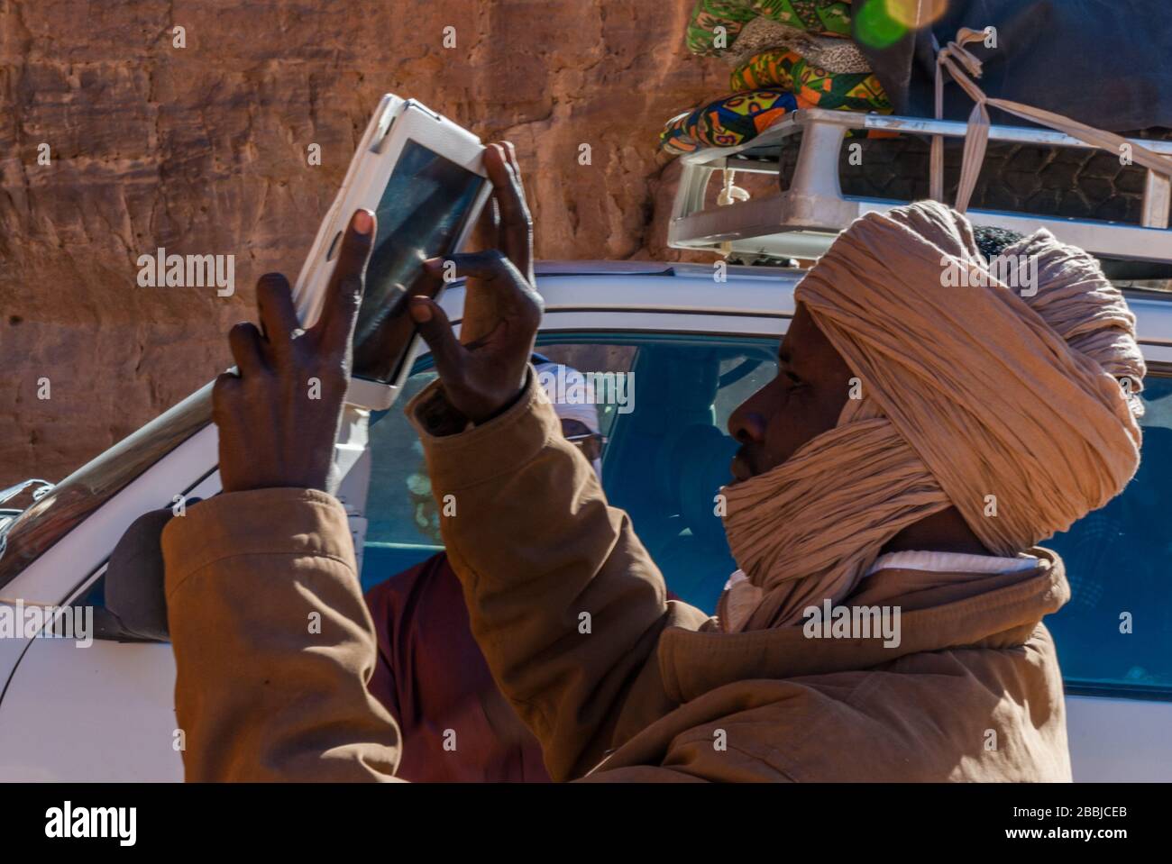 Tibesti, Chad - 31/12/2012. Young local man from Chad is making a photo ...