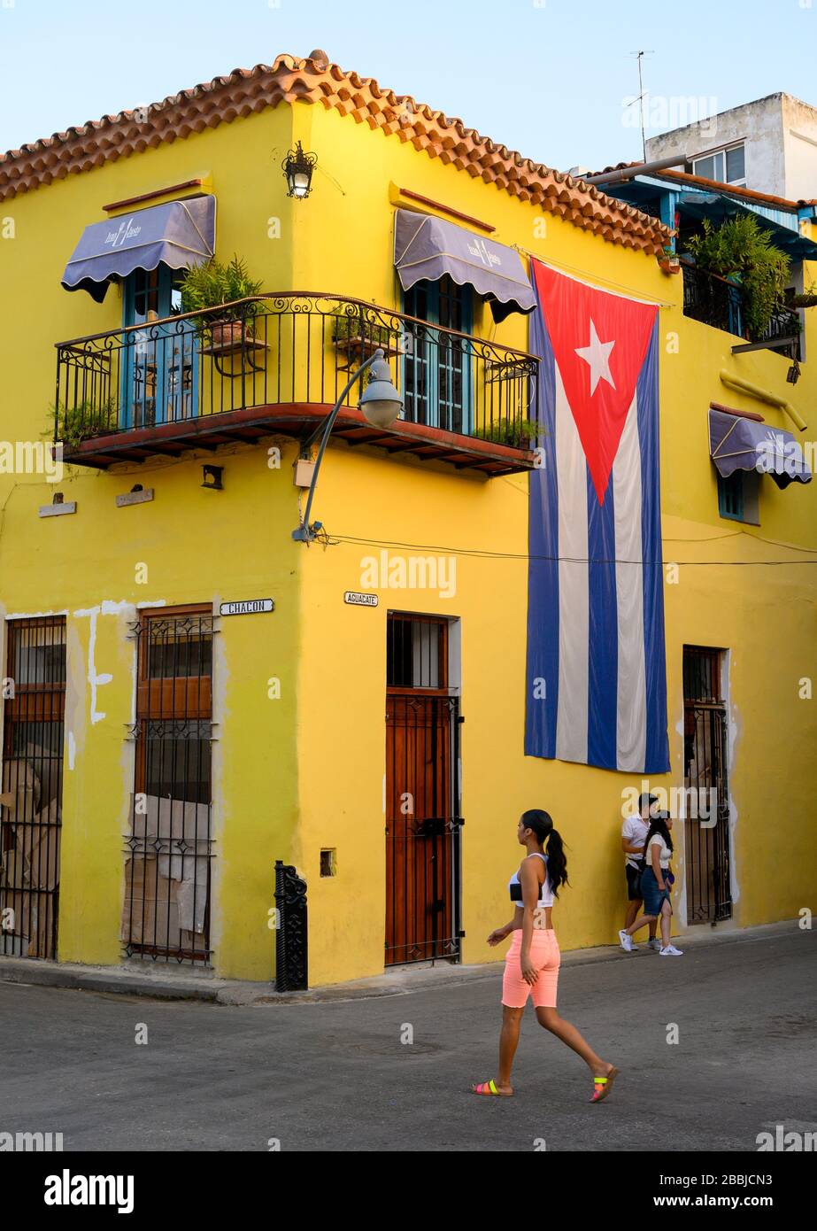 Yellow building with cuban flag at aguacate and chacon hires stock