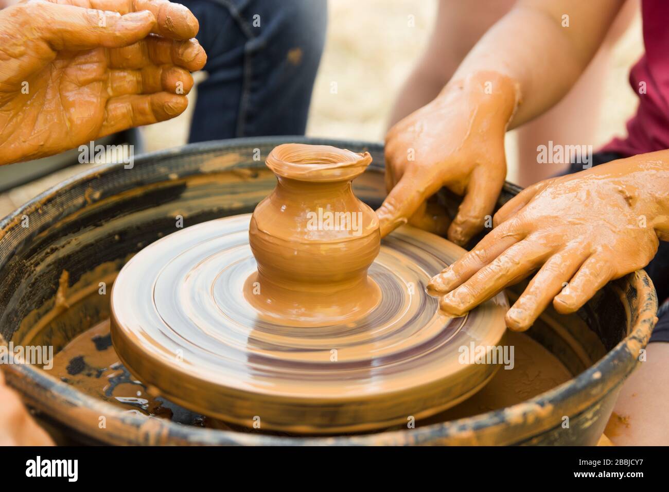 A close up view on ceramic production process on potter's wheel with ...