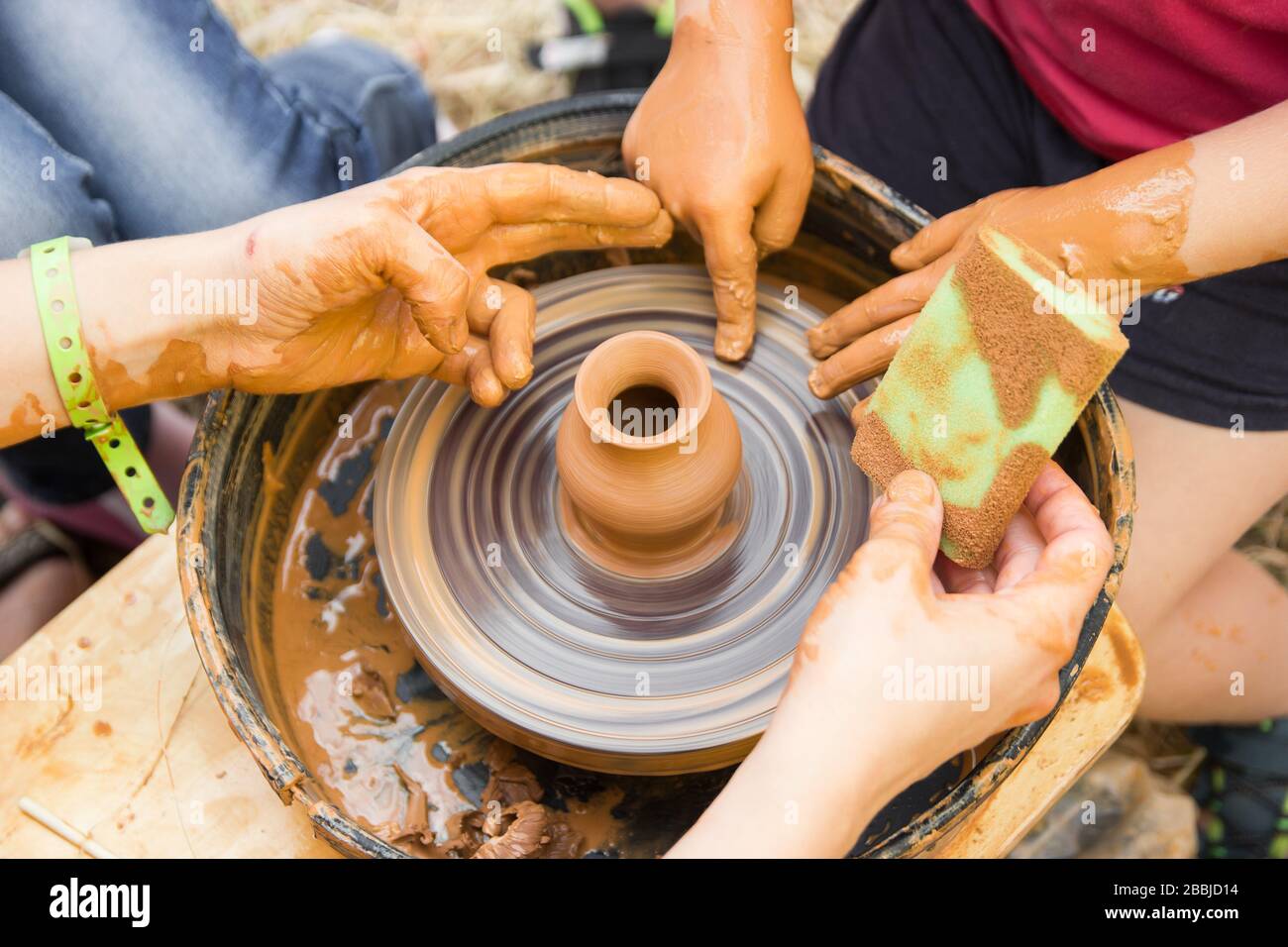 A close up view on ceramic production process on potter's wheel with ...