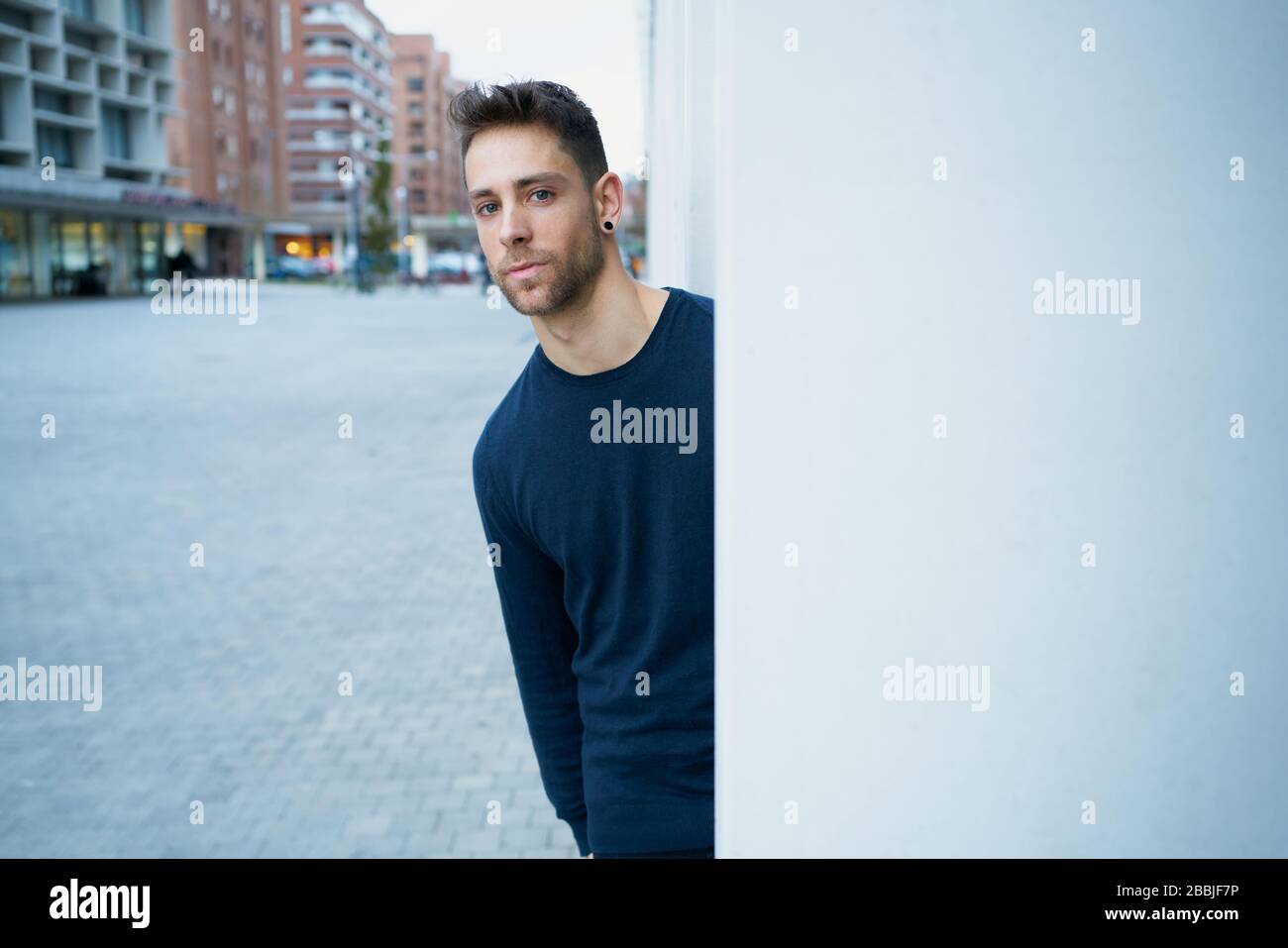the modern man in casual clothes leaning against a wall Stock Photo