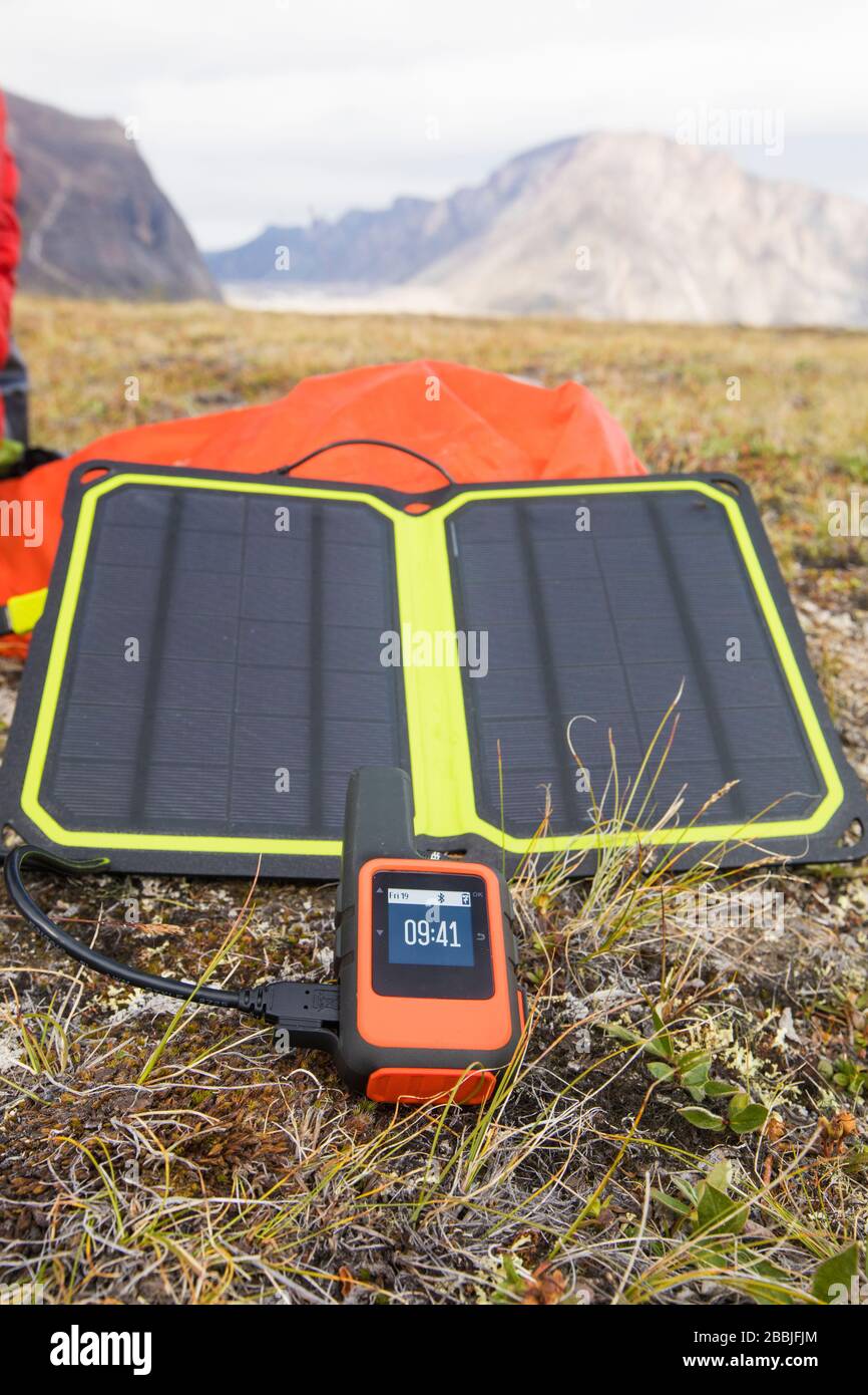 Solar charger is used to power GPS unit in remote location. Stock Photo