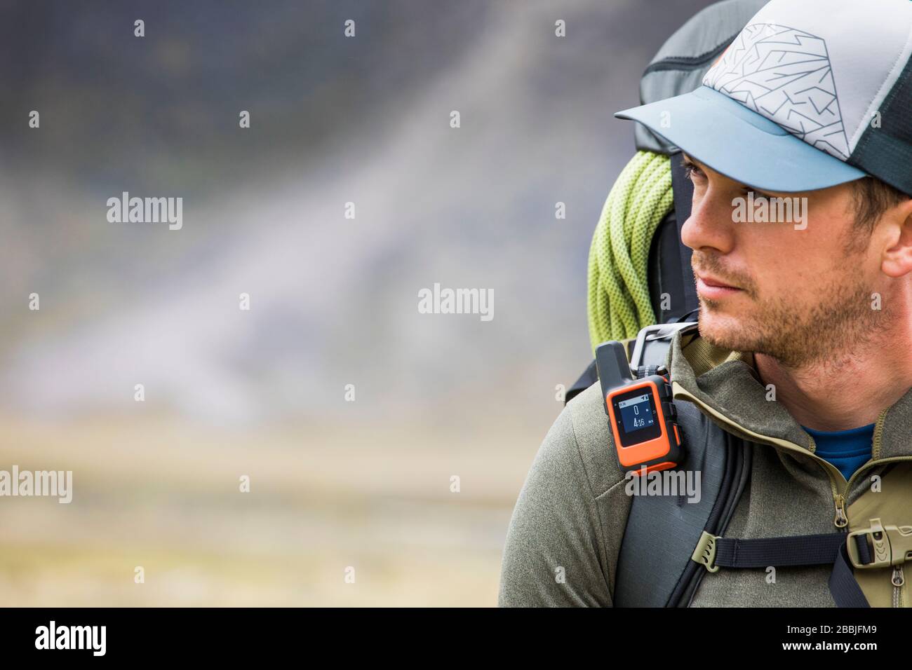 Portrait of backpacker hiking with GPS tracker (tracking) on Stock Photo Alamy