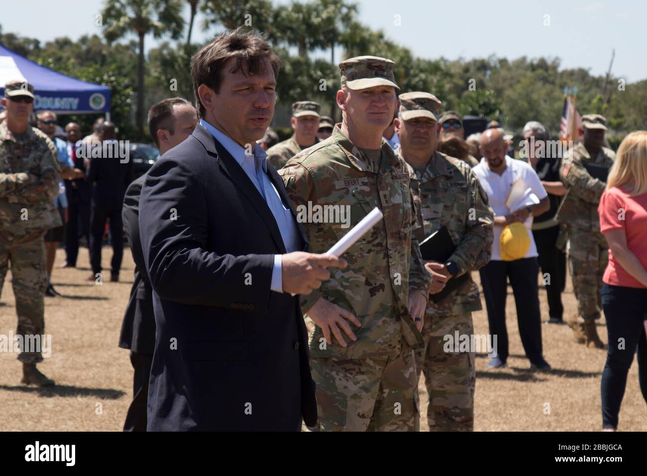 Florida Gov. Ron DeSantis, left, addresses Florida National Guardsmen with U.S. Air Force Maj. Gen. James O. Eifert, the Adjutant General of the Florida National Guard, right, on the COVID-19 pandemic March 30, 2020 in West Palm Beach, Florida. DeSantis has been criticized for his slow response to the pandemic and failure to impose strict guidelines on social distancing to prevent the spread of the virus. Stock Photo