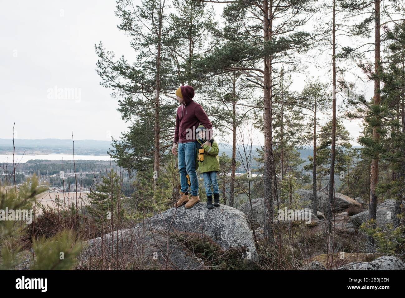 Father and son hiking in forest. Looking at map Stock Photo - Alamy