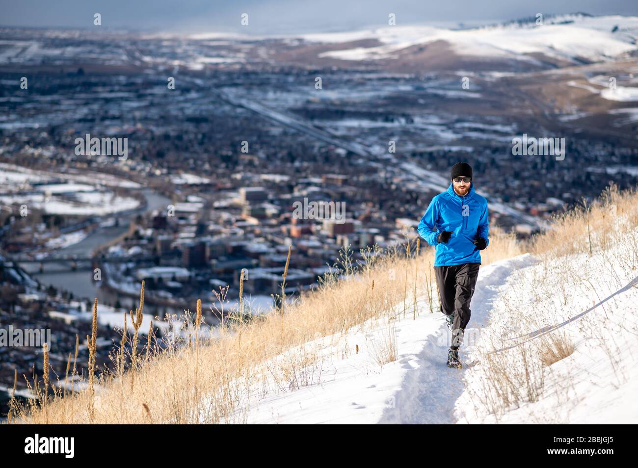 Male runner nearing the top of Mount Sentinel in Missoula MT. Stock Photo