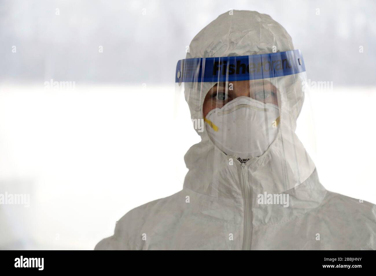 U.S. Army Sgt. Cora Brown is trained in proper use of protective gear before assisting with COVID-19, coronavirus pandemic testing at Community College of Rhode Island March 30, 2020 in Warwick, Rhode Island. Stock Photo