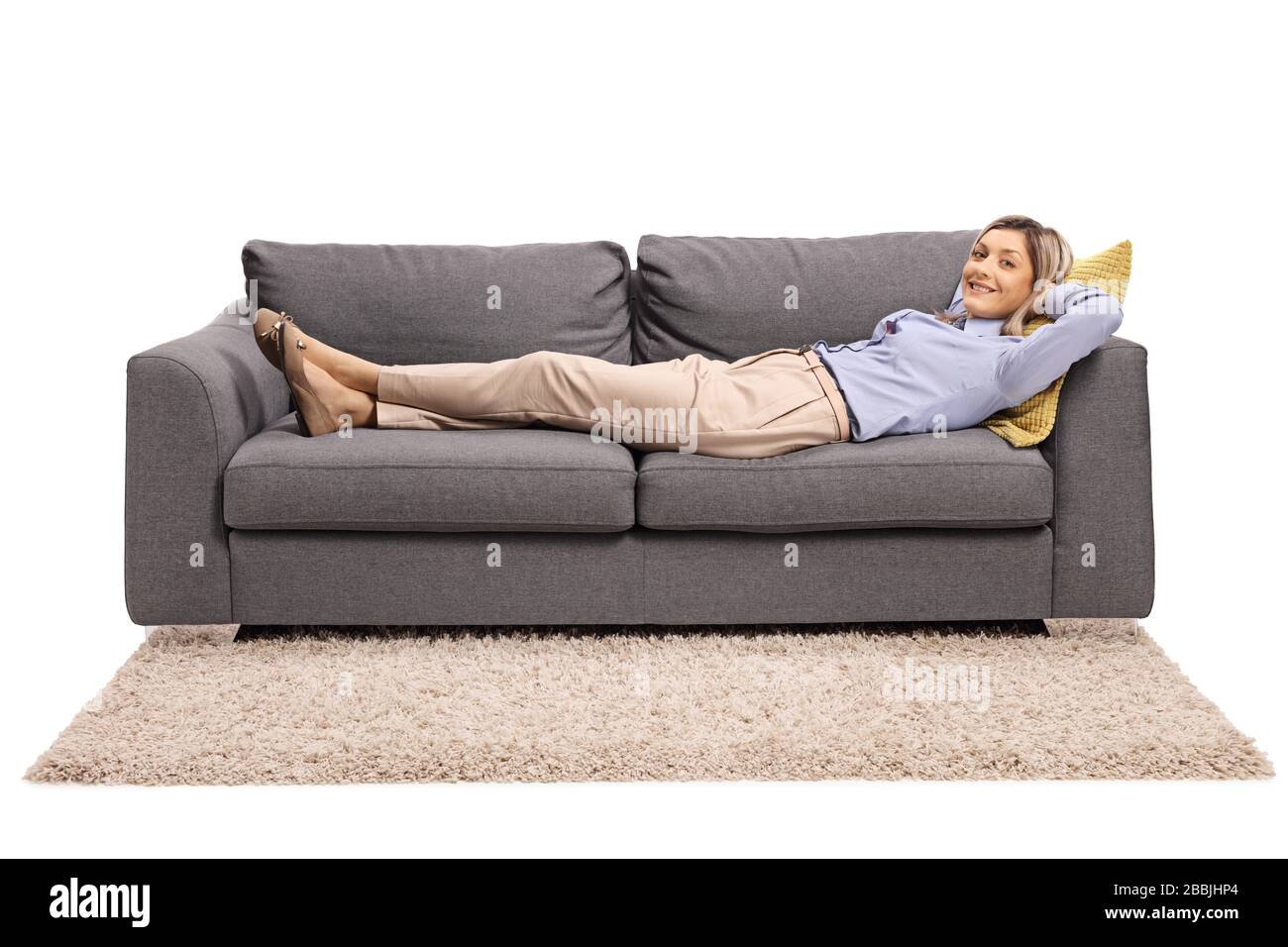 Young woman lying on a sofa isolated on white background Stock Photo ...