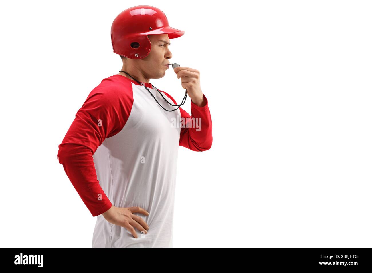 Profile shot of a baseball coach using a whistle isolated on white background Stock Photo