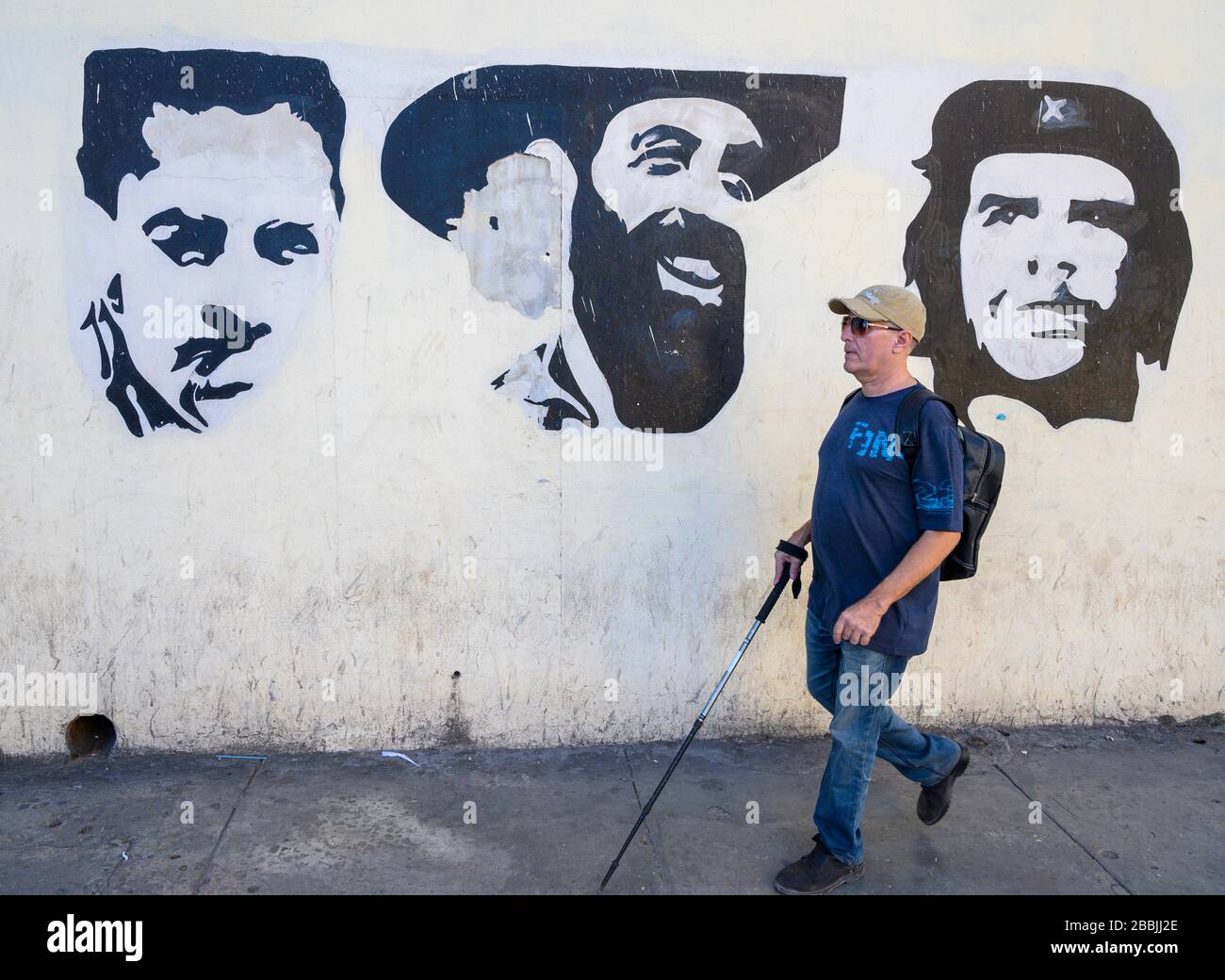 Sight disabled person and mural, with Che Guevera  and Camilo Cienfuegos, Havana, Cuba Stock Photo