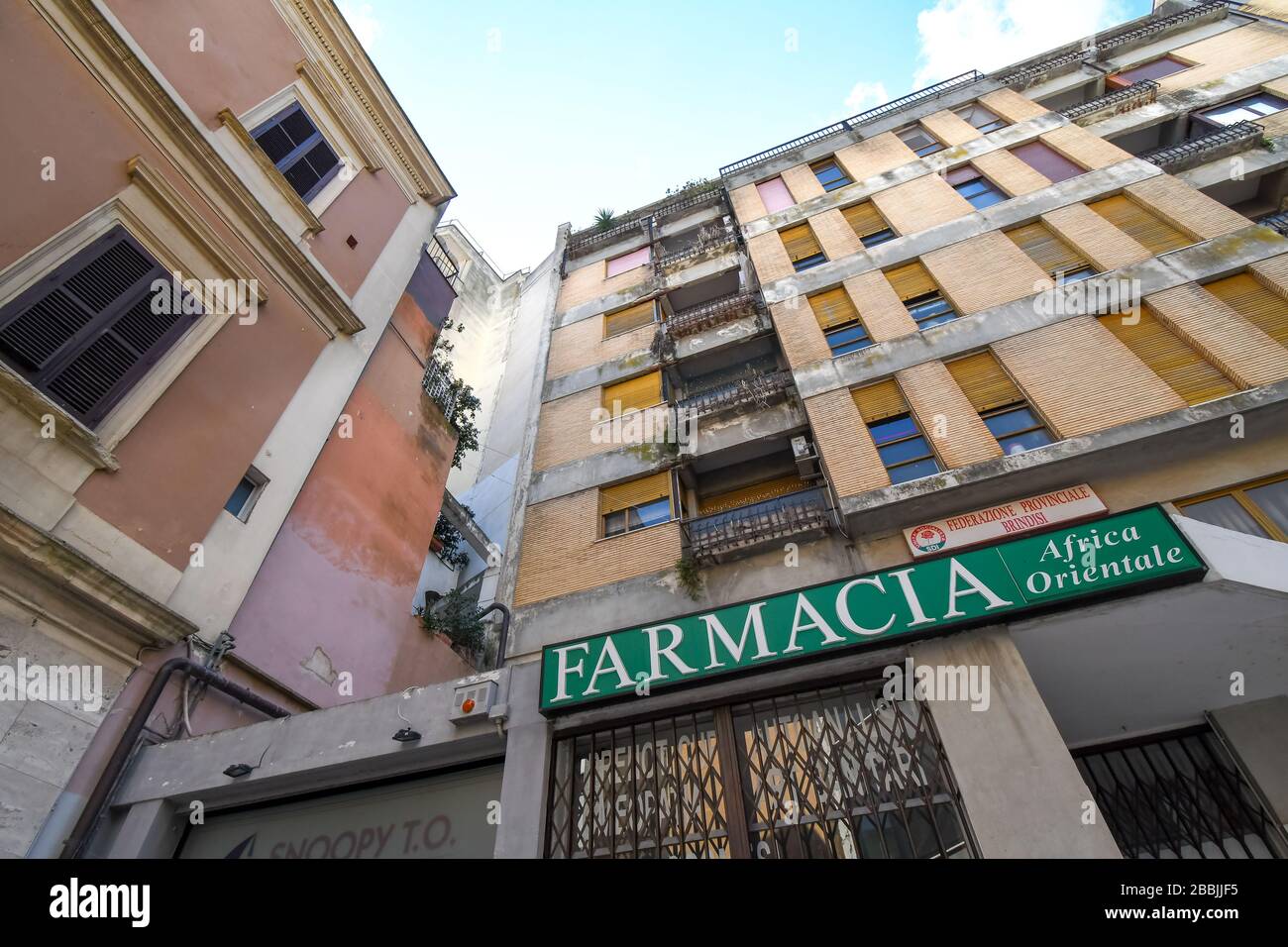 A farmacia, or pharmacy, located on the ground floor of a residential apartment in the city of Brindisi, Italy. Stock Photo