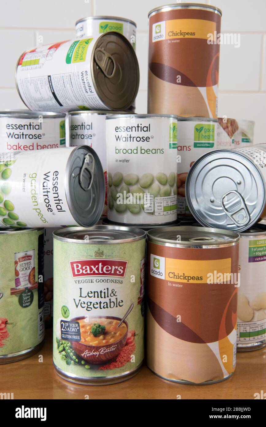 Tinned Food piled up on the work surface Stock Photo