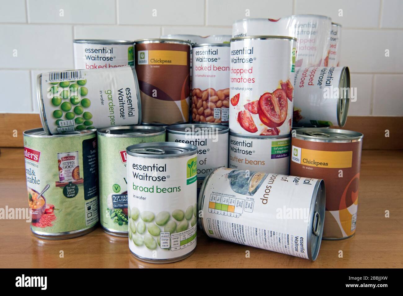 Tiñned Food piled up on the work surface stockpiled during Coronavirus  corvid 19 lockdown Stock Photo