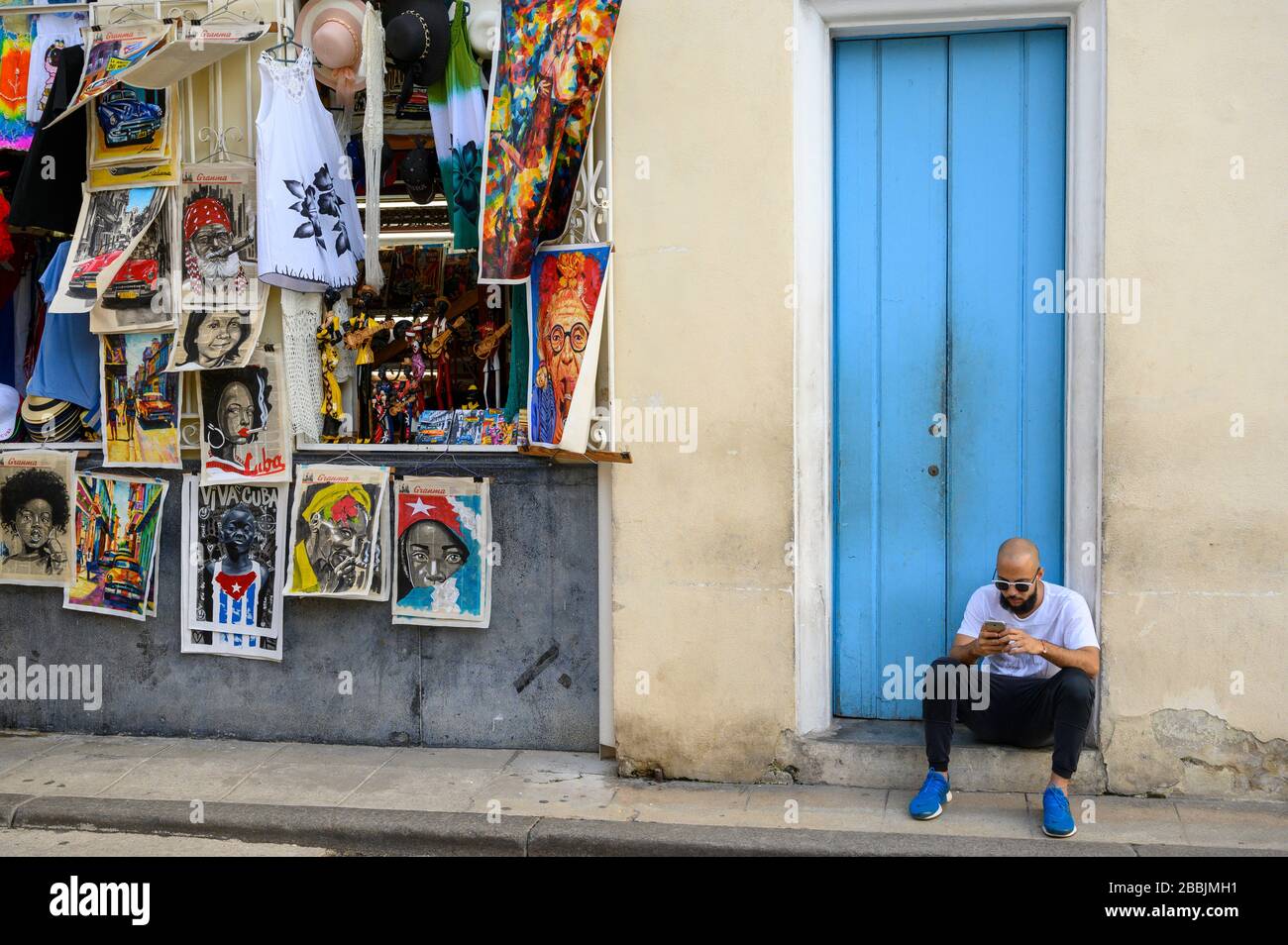 Souvenier shop with man on doorstep, Havana, Cuba Stock Photo