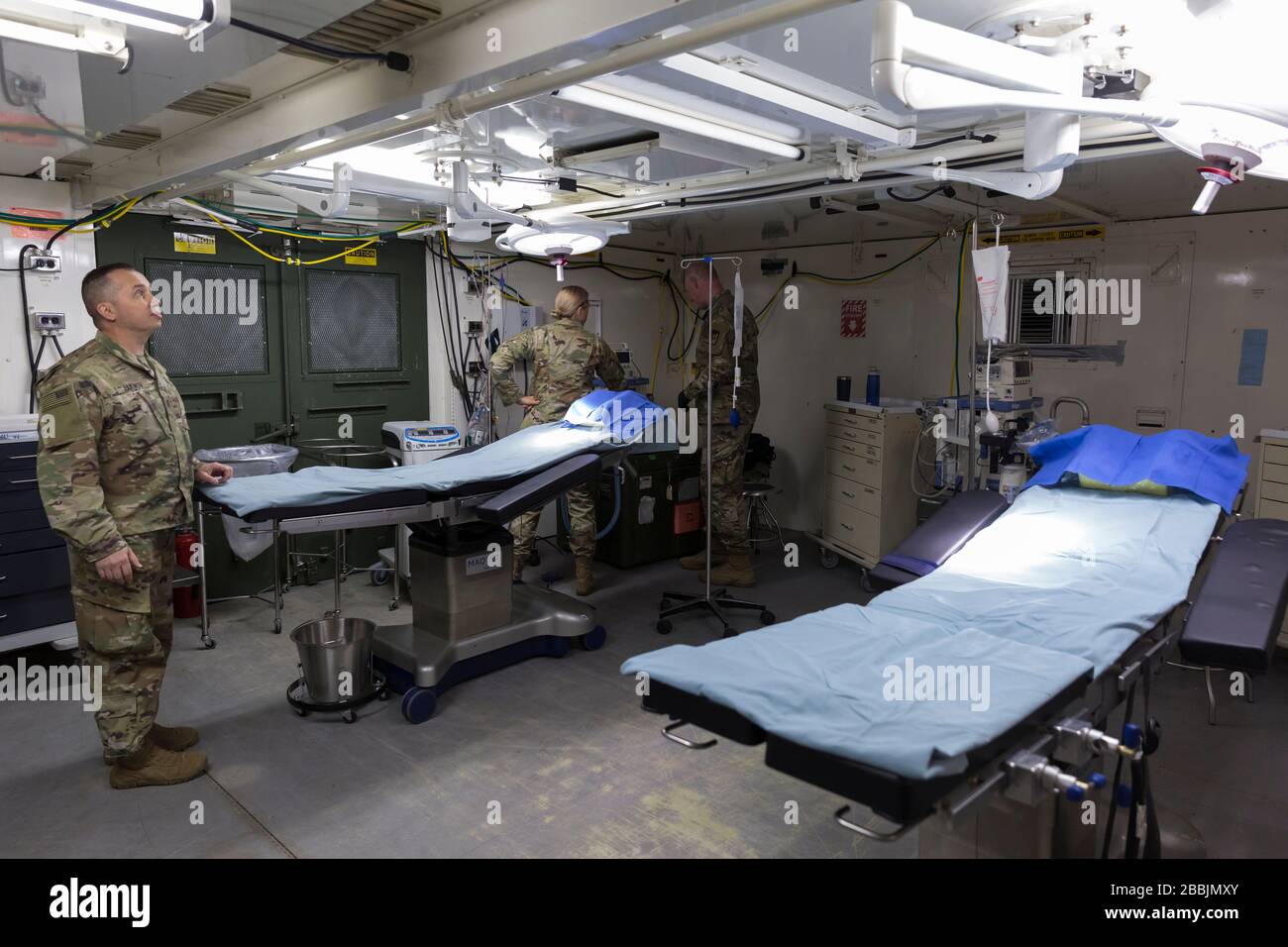 Soldiers assemble the operating room at the field hospital in