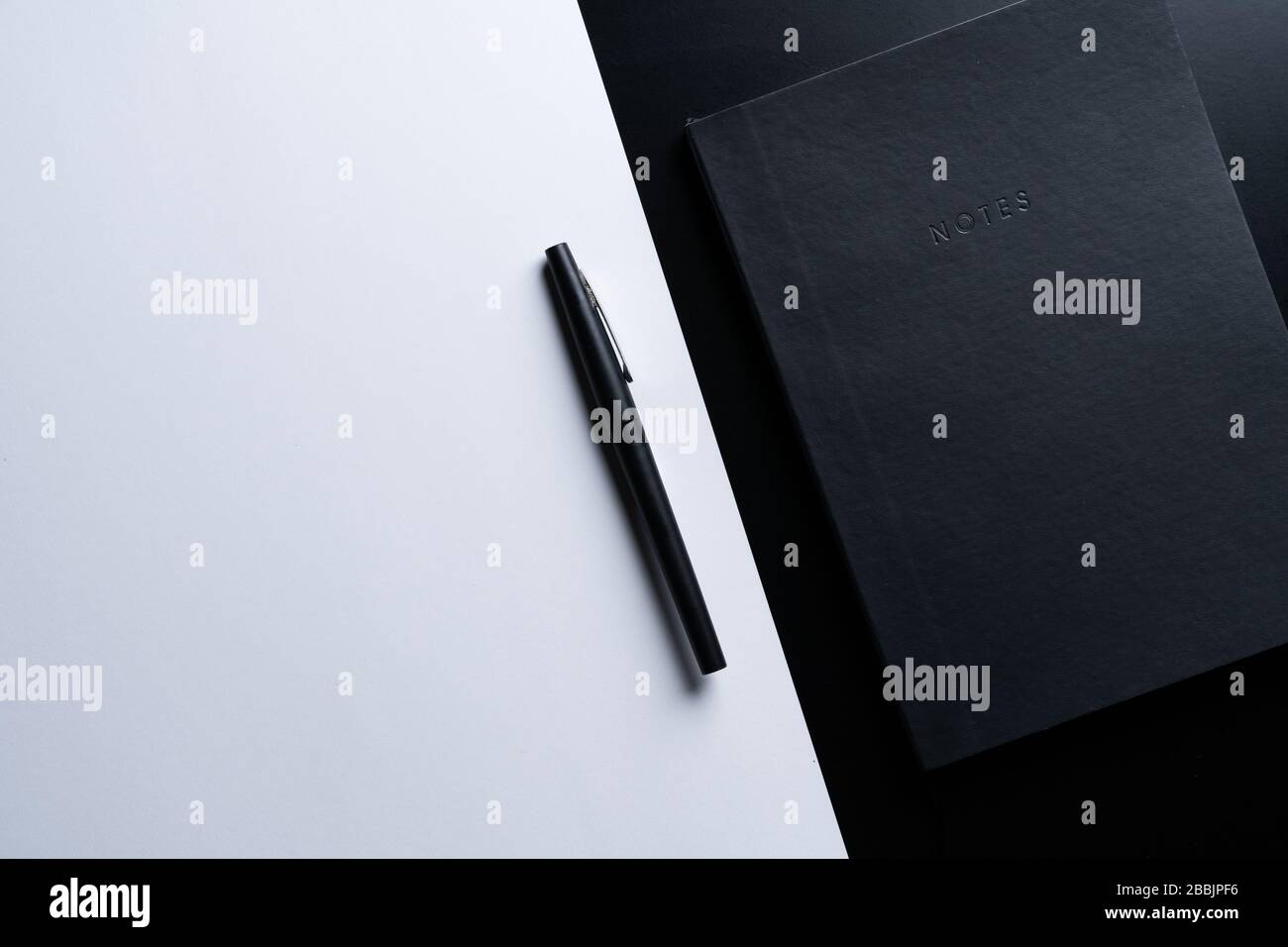 Black style set: notepad and pen on Black background. Stock Photo