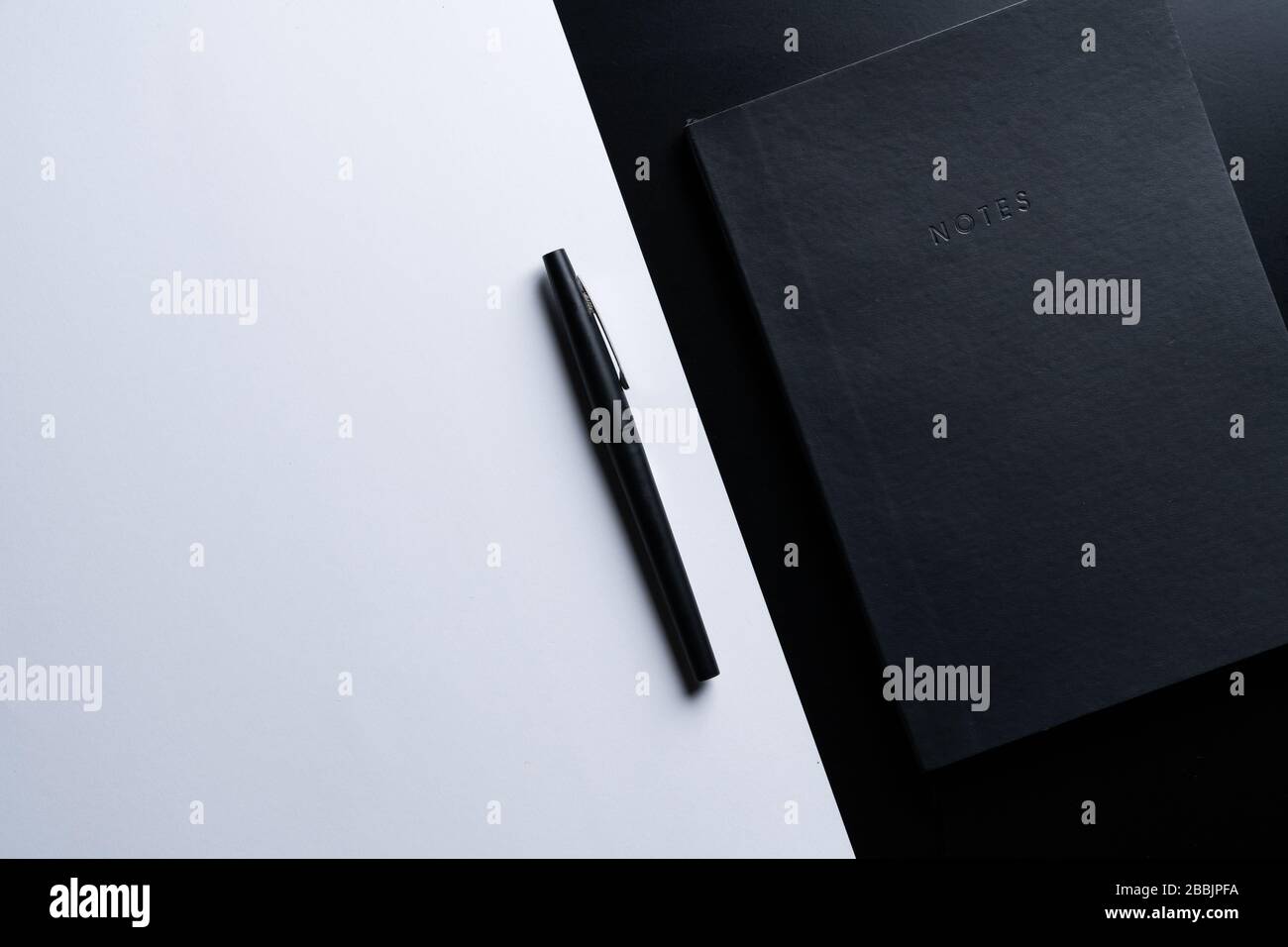 Black style set: notepad and pen on Black background. Stock Photo