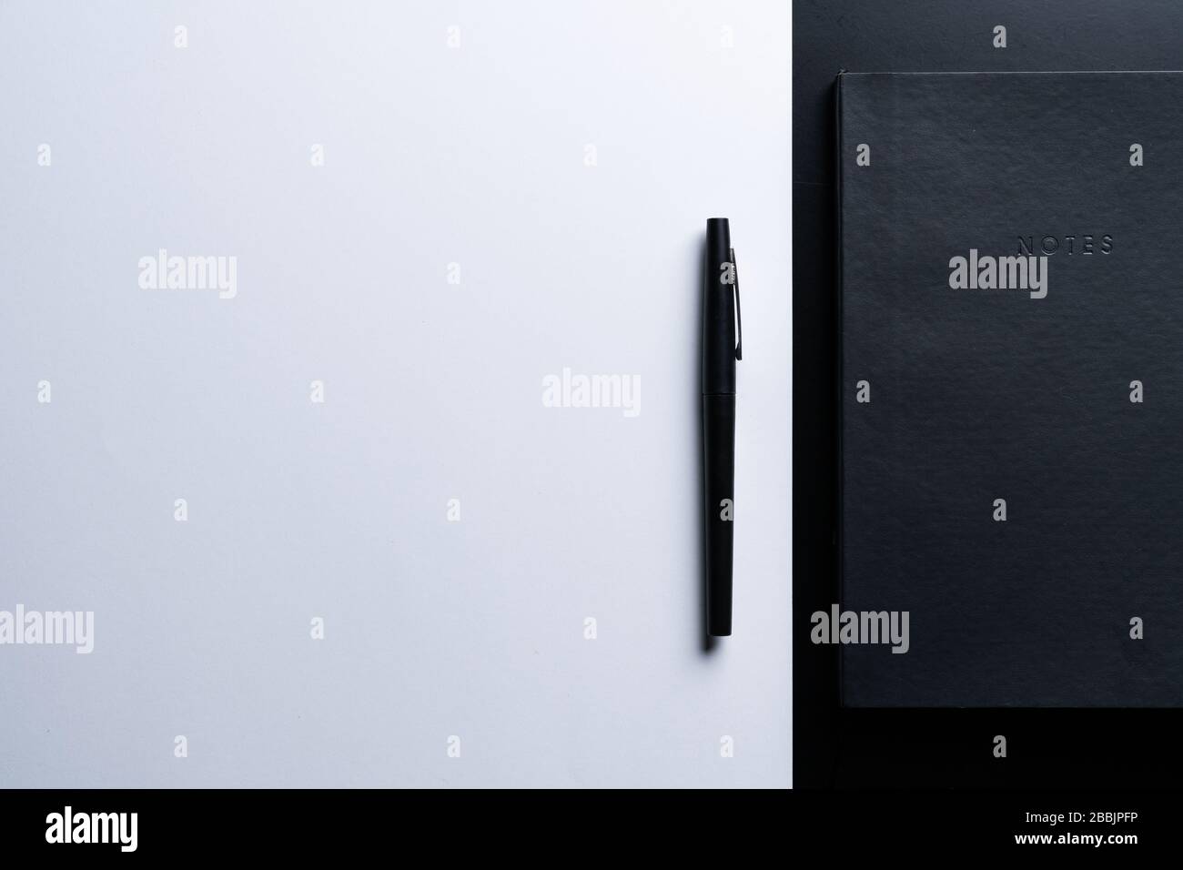 Black style set: notepad and pen on Black background. Stock Photo
