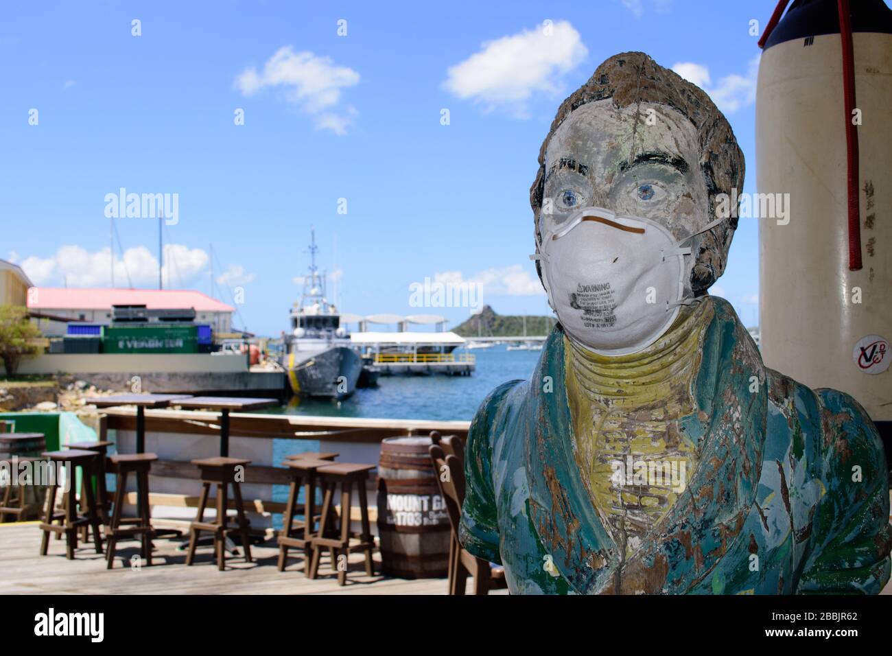 The bar mascot at the Sint Maarten Yacht Club Bar & Restaurant wears a (used) face mask while it is closed for the Covid-19 Pandemic in late March '20 Stock Photo