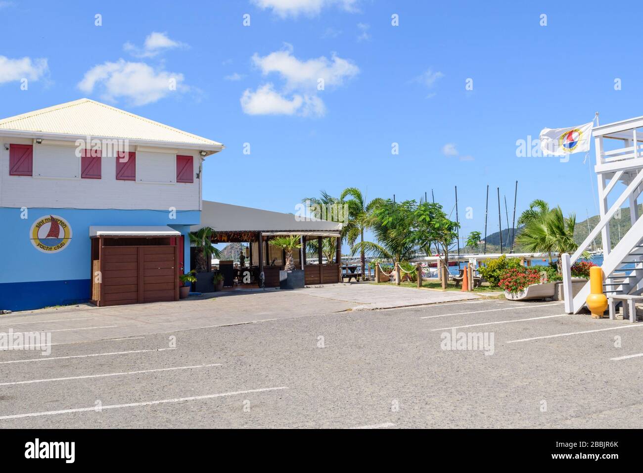 Empty parking lot at Sint Maarten Yacht Club Bar & Restaurant during closure for Covid-19 Pandemic in late March 2020 Stock Photo