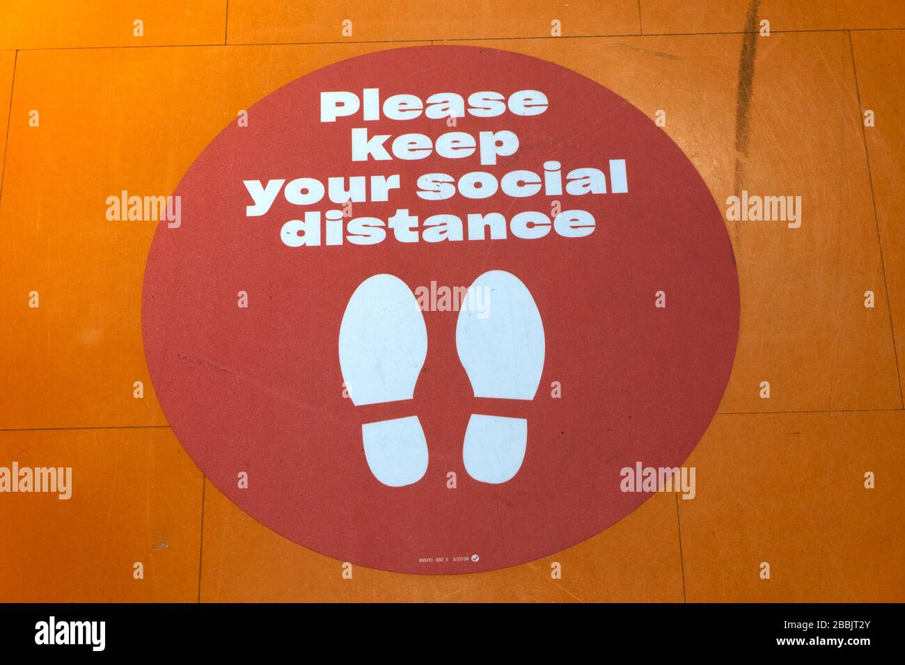 Vancouver, Canada, 31 March 2020. A sign on the floor of store reminds customers to practice social distancing  during the evolving COVD-19 pandemic. Stock Photo