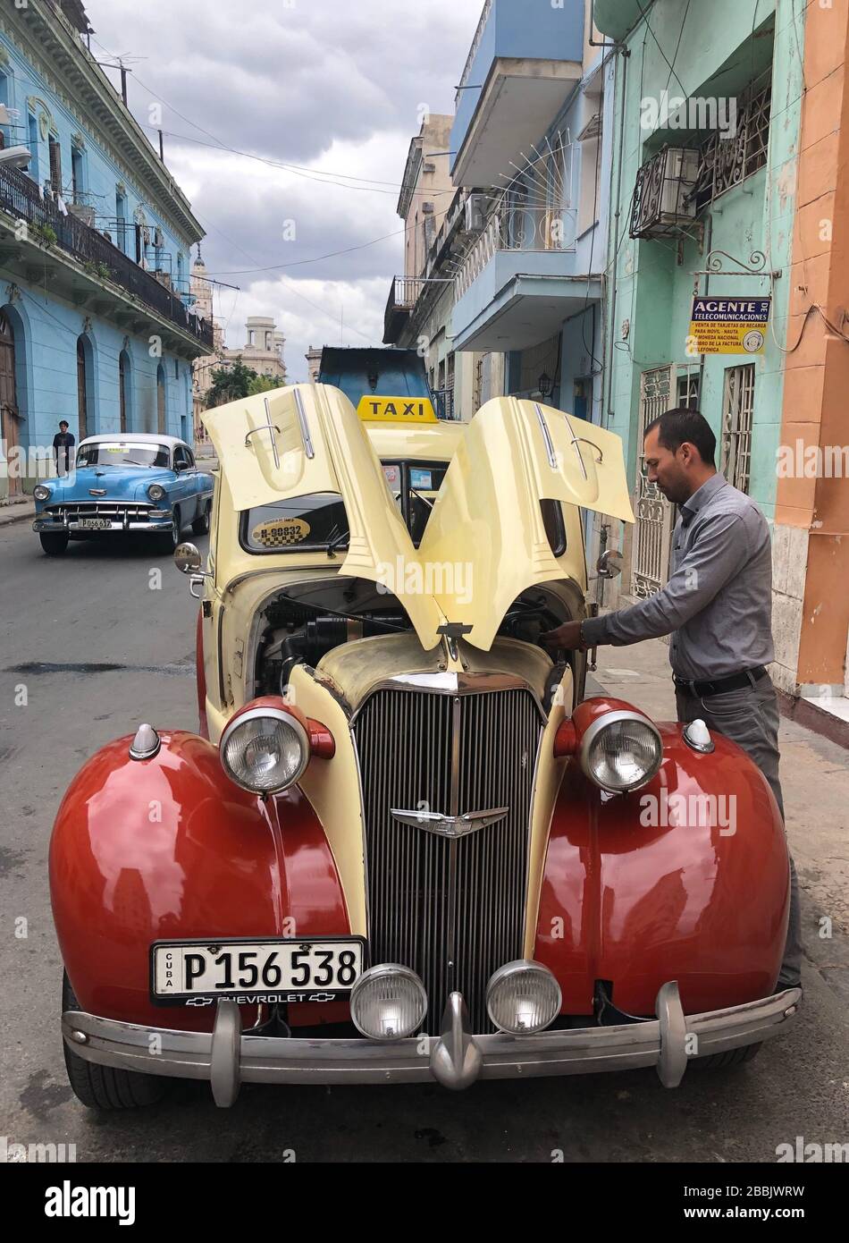 Applying service to classic Chevrolet car, Havana, Centro,  Cuba Stock Photo
