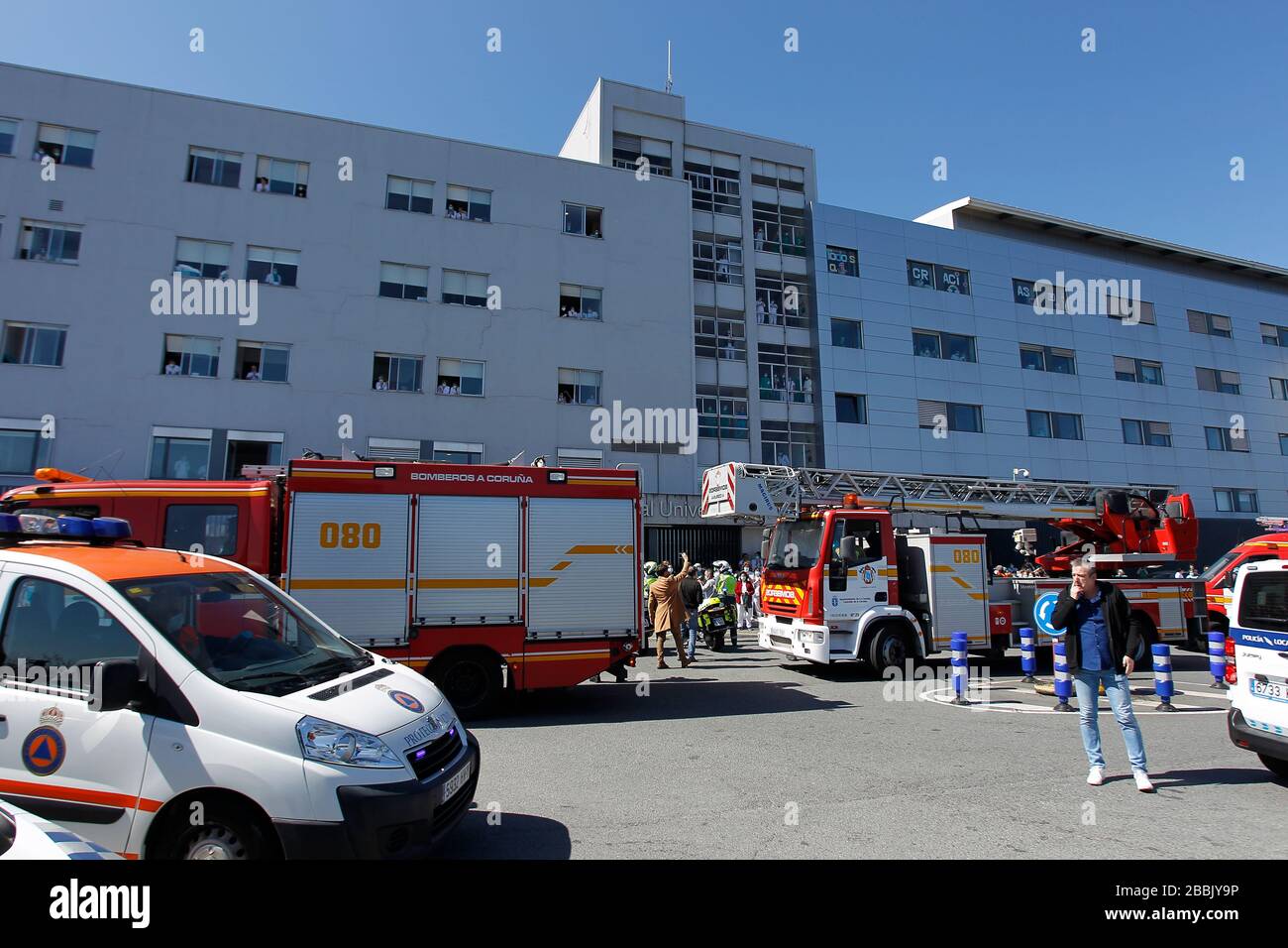 A Coruna-Spain.Firefighters with masks inside fire trucks during a tribute to the emergency services on March 26,2020 Stock Photo