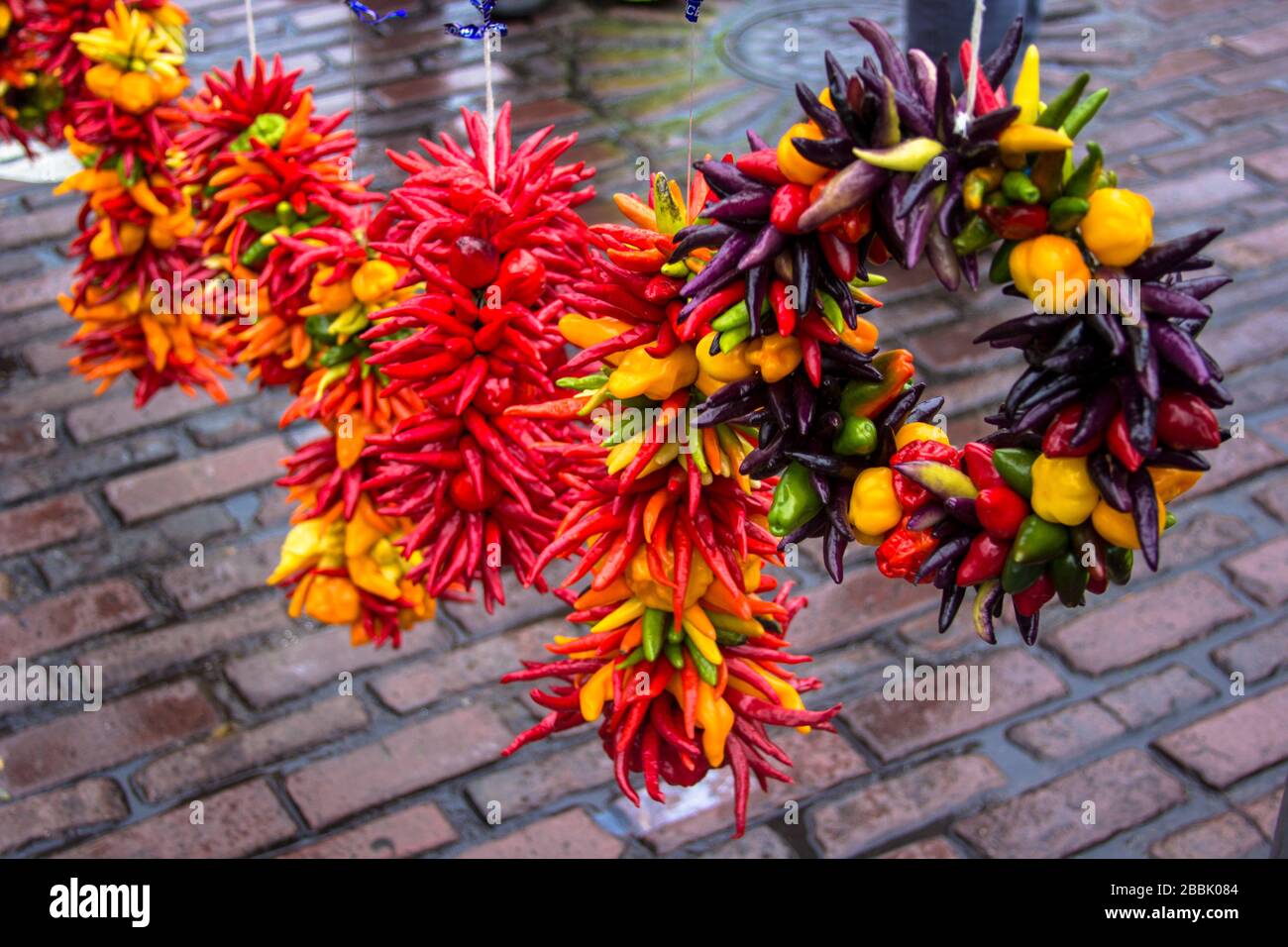 Wreaths of peppers for sale at a vendor booth at a farmer's market Stock Photo