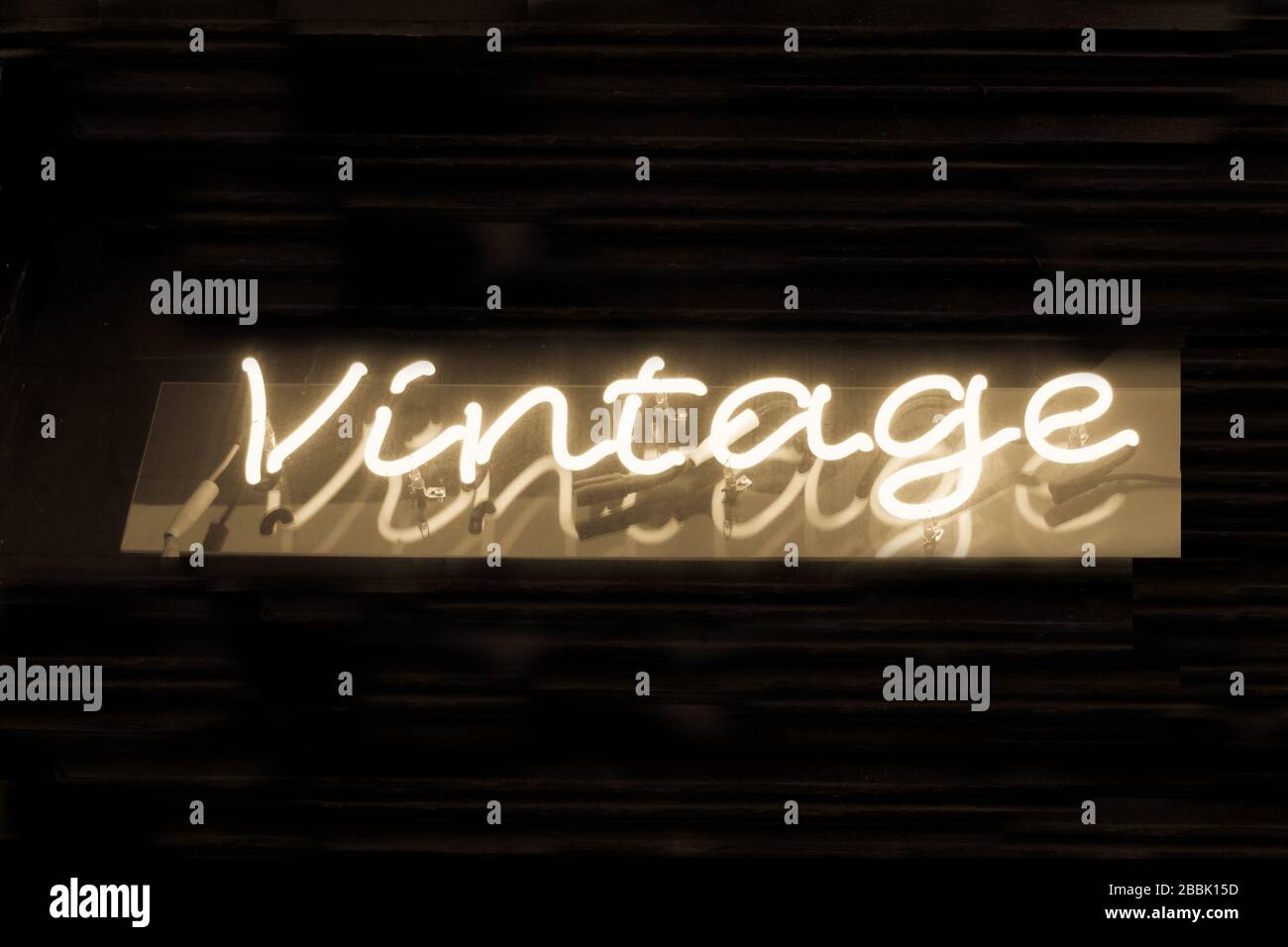 A neon sign that reads 'Vintage' in sepia tone Stock Photo