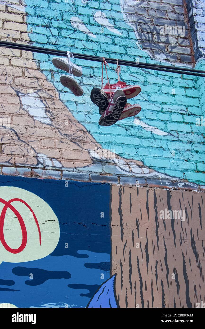 Shoes hanging on power lines in a city Stock Photo Alamy