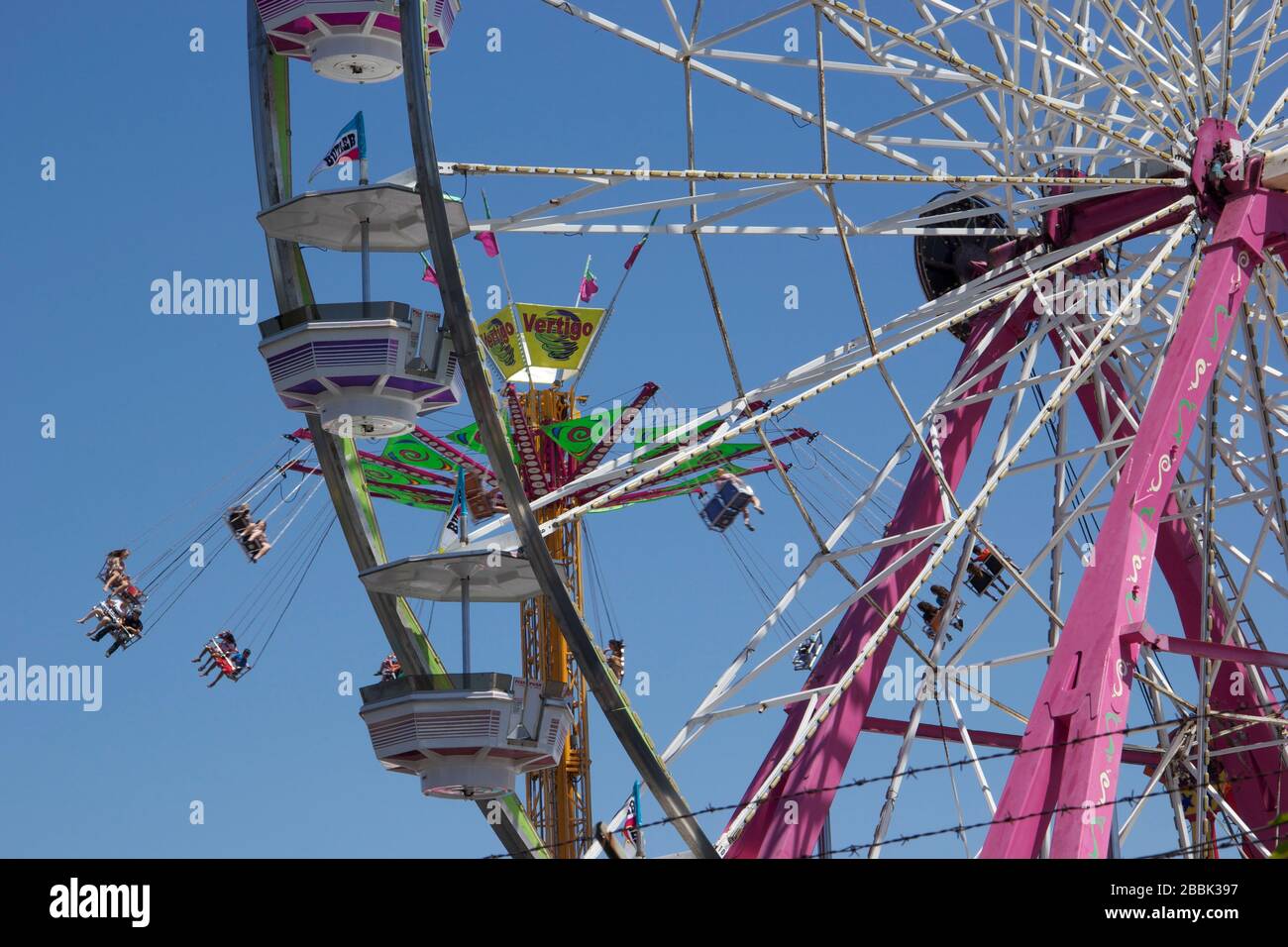 A ferris wheel and swing rides at a summer county fair Stock Photo Alamy