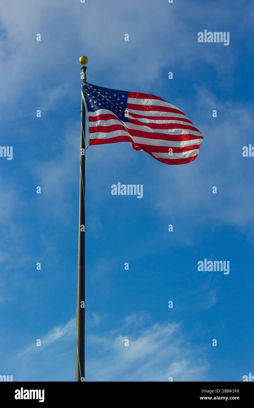American flag waving in a sunny blue sky with white clouds Stock Photo ...