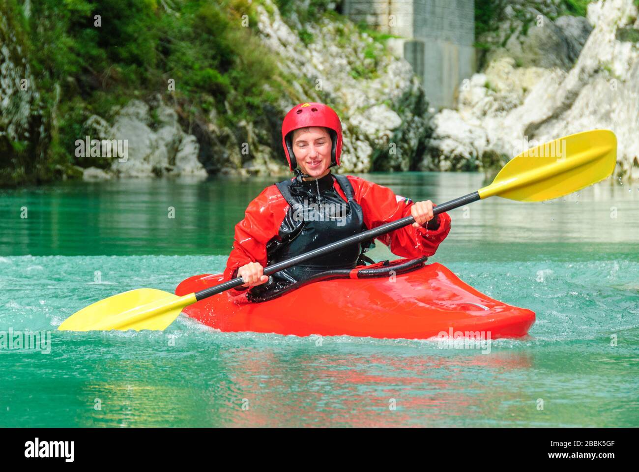 A group of kayakers on the way on soca river in southern alps Stock Photo