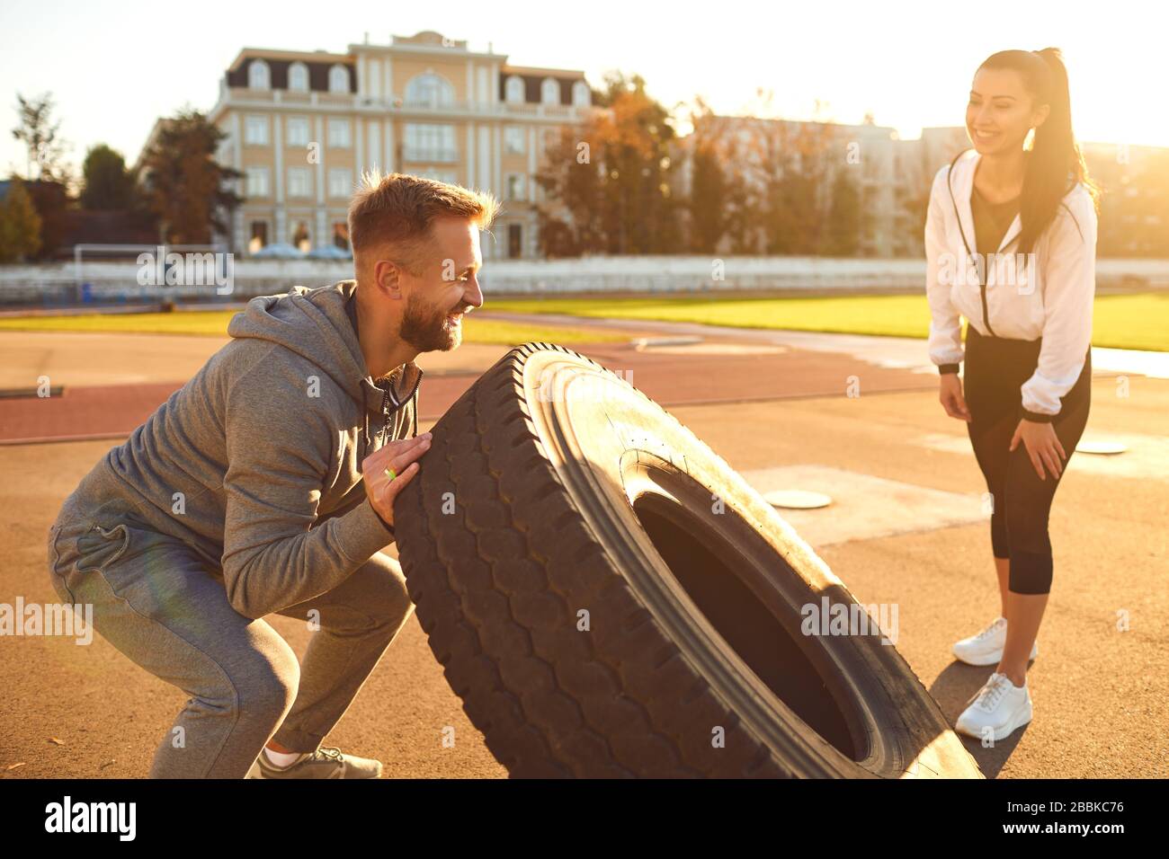 Man and woman doing crossfit outdoors. Stock Photo