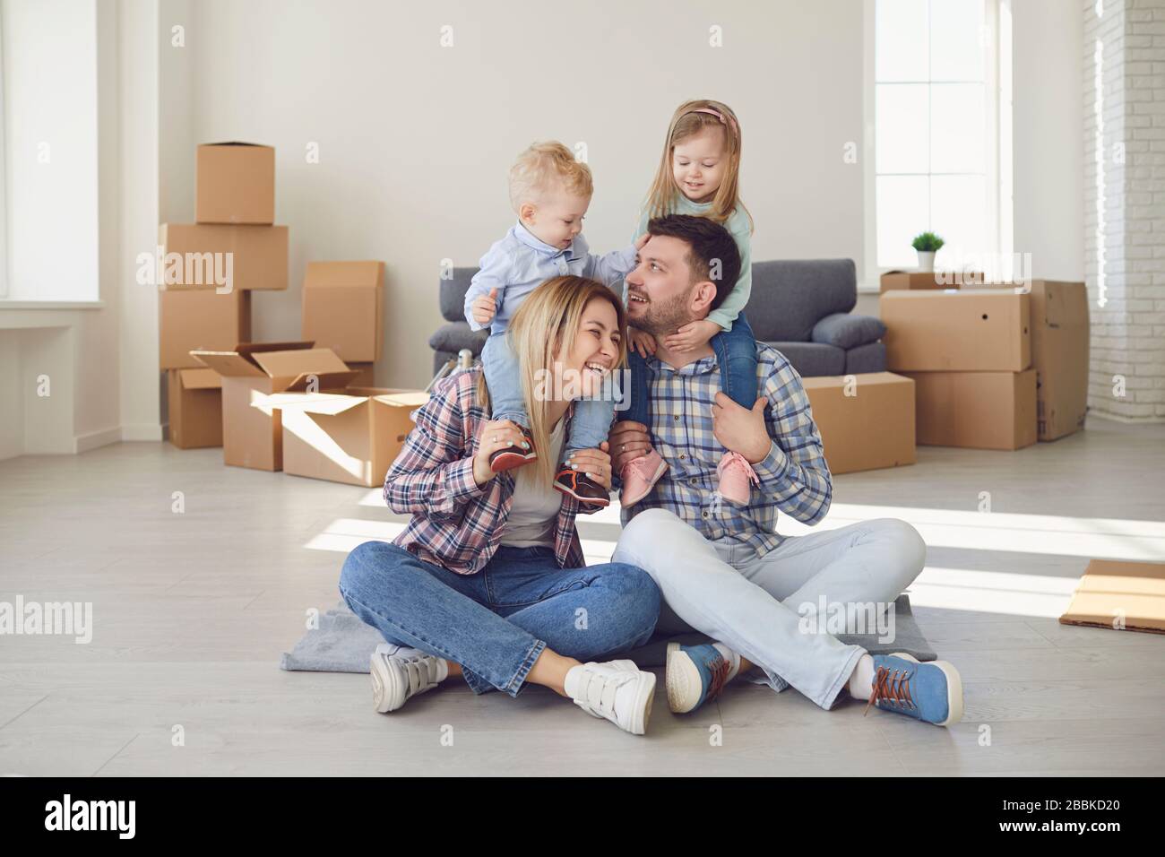 Happy family smiling at a new house moving. Stock Photo
